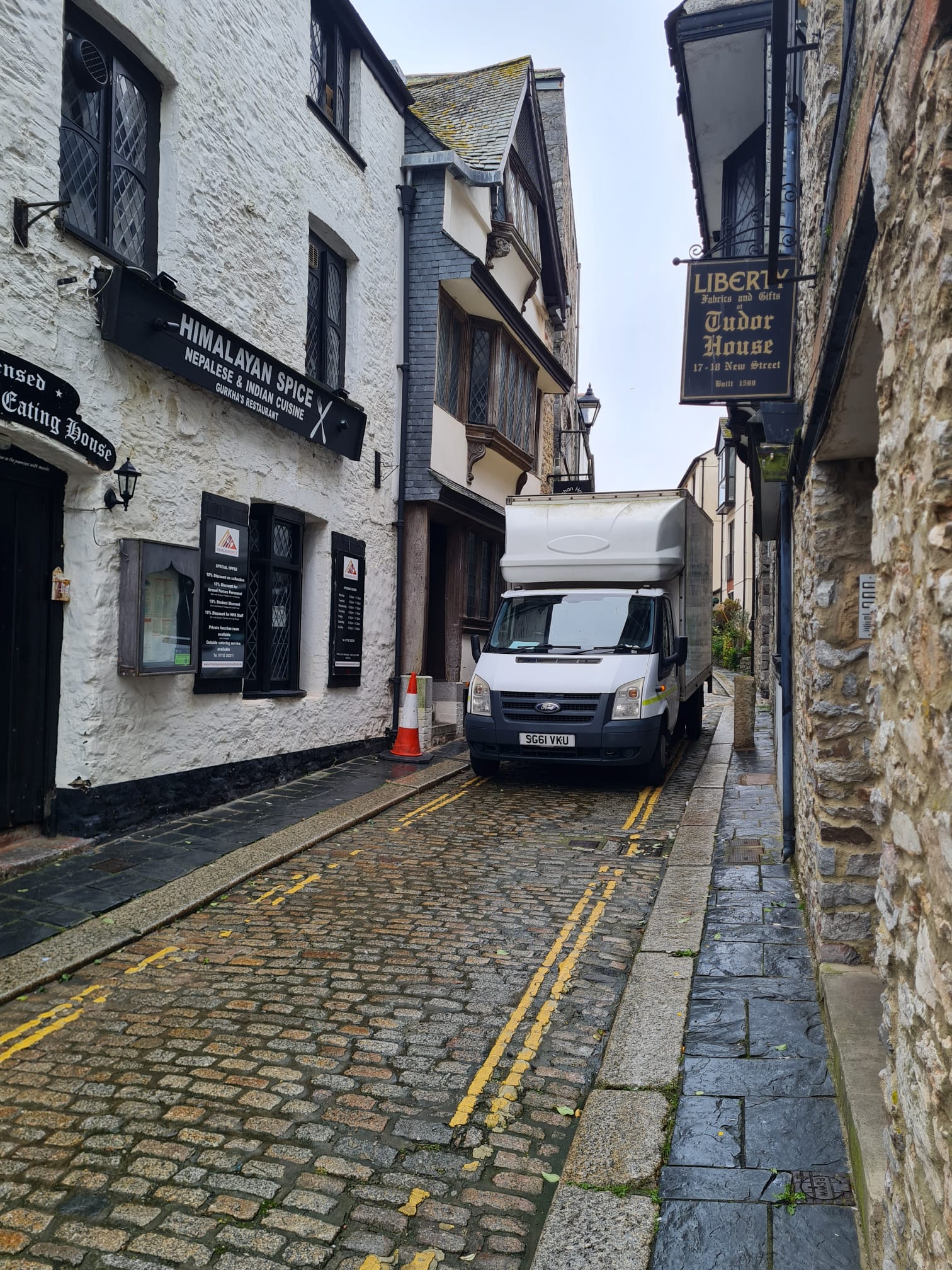A Moving On Removals van carefully navigating the narrow, historic cobbled streets of The Barbican, Plymouth, demonstrating local expertise in difficult access moves.