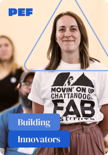 Young professional smiling at a community event, representing PEF programs that develop and empower future leaders.