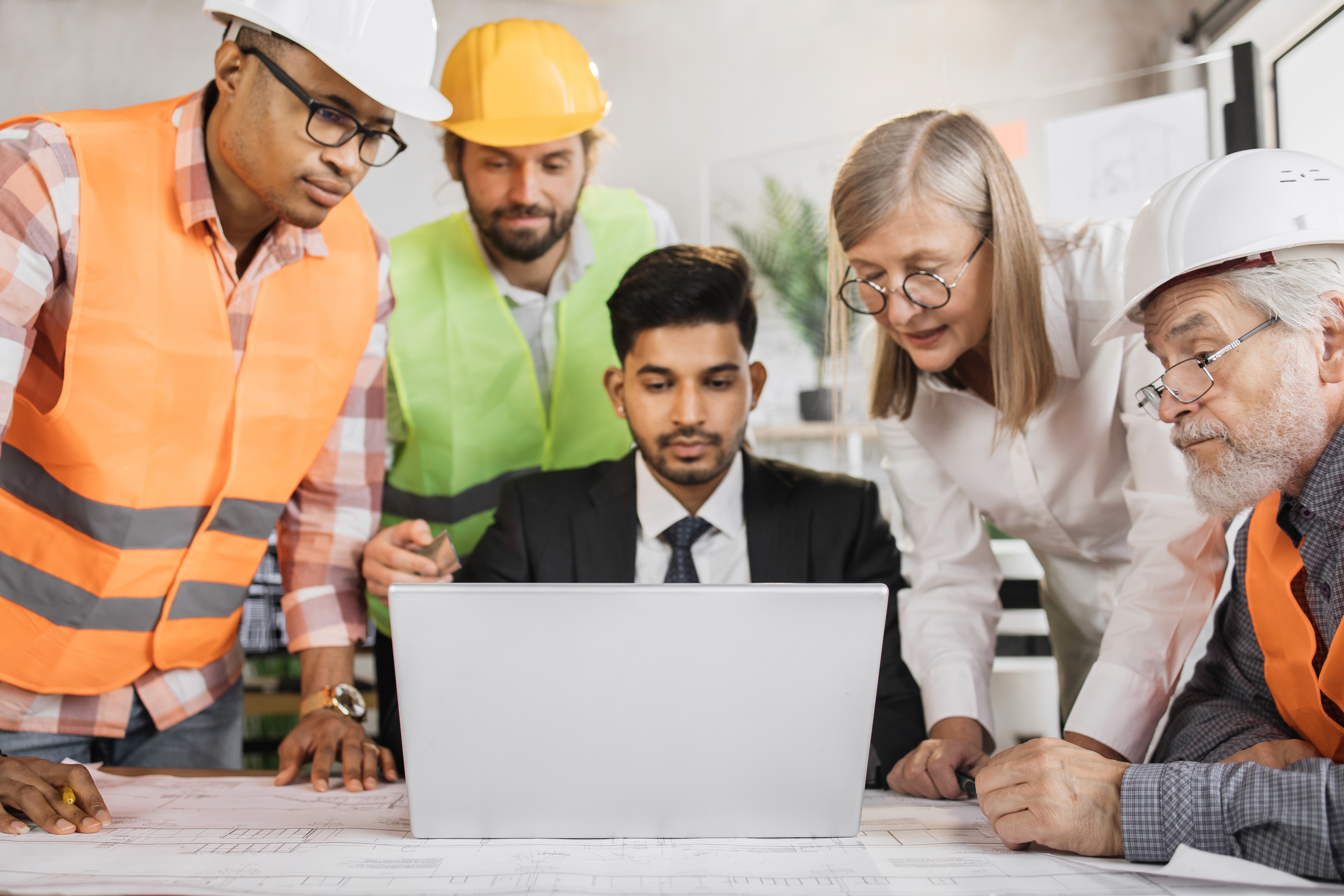 Construction company leadership team reviewing project and pipeline data, representing construction marketing, construction digital marketing, and marketing for construction companies.