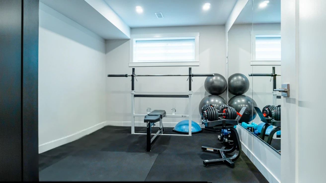 Dedicated home gym and fitness room with professional equipment in custom Burnaby residence by Vancouver Custom Homes