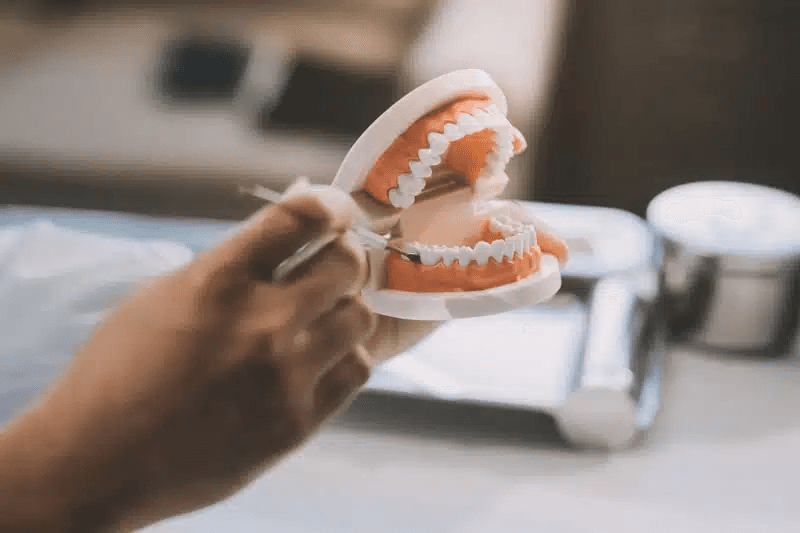 Image of doctor holding a denture
