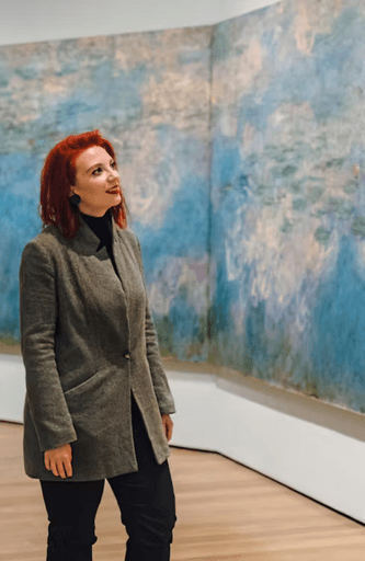 A guest appreciates a painting at the Museum of Modern Art in NYC