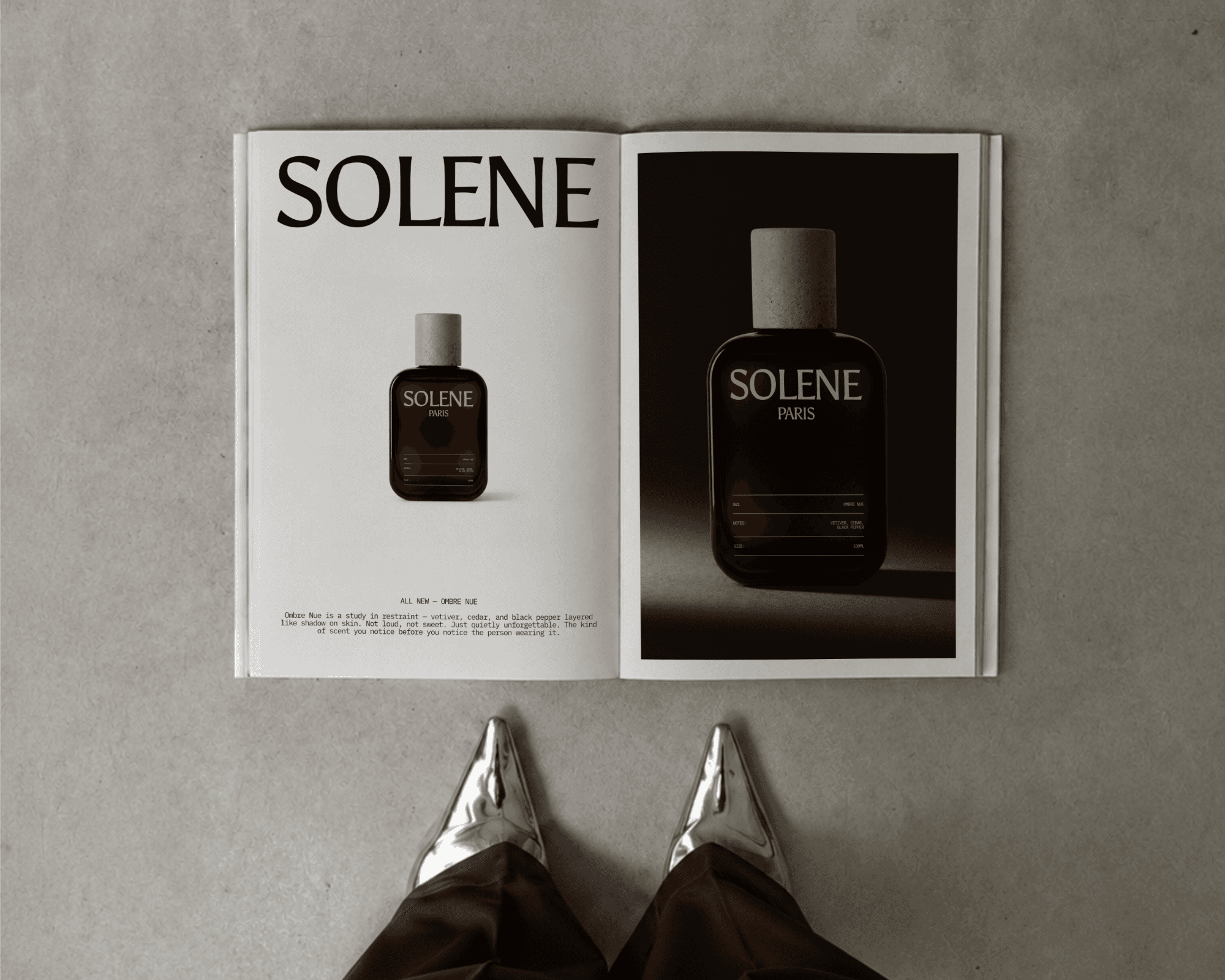 A magazine laying on the ground with two advertisements for a perfume brand called SOLENE Paris printed on the pages.