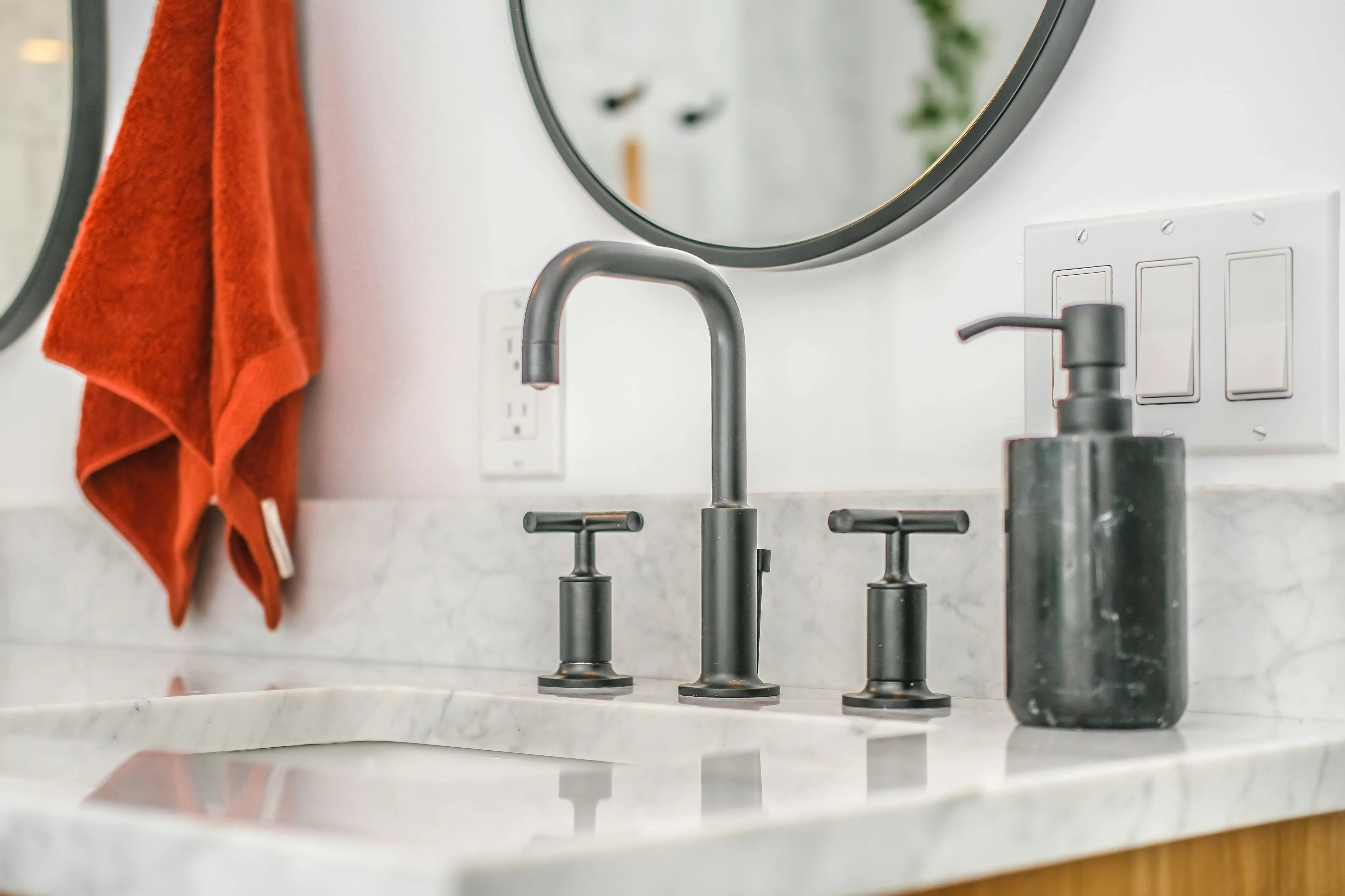 Steel faucet on a white ceramic sink