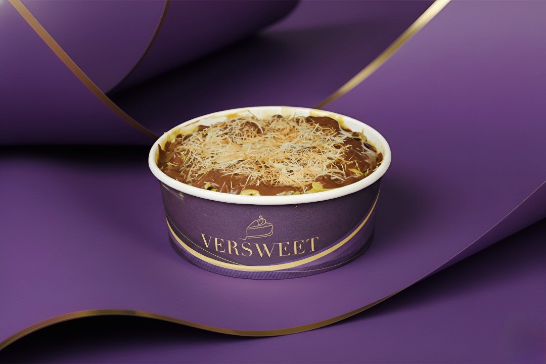 Barista pouring milk into latte with art