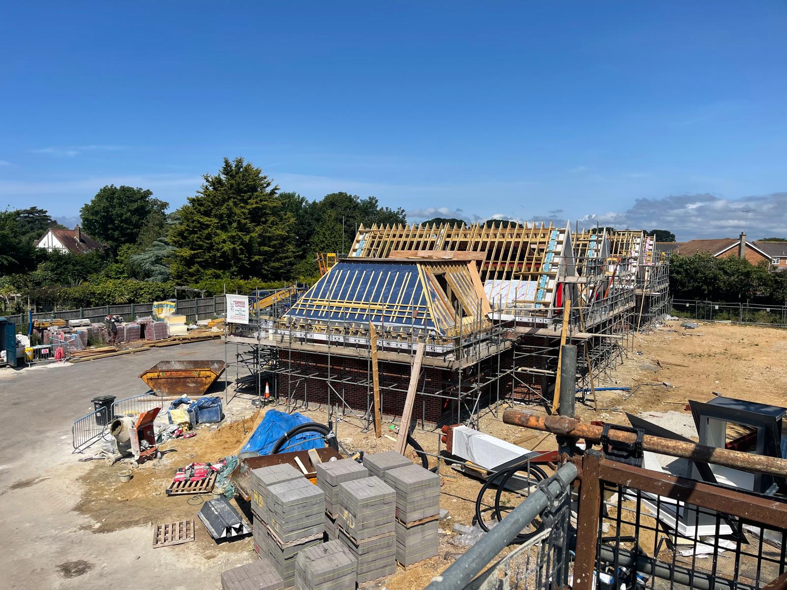 A residential building under construction. The roof is being built