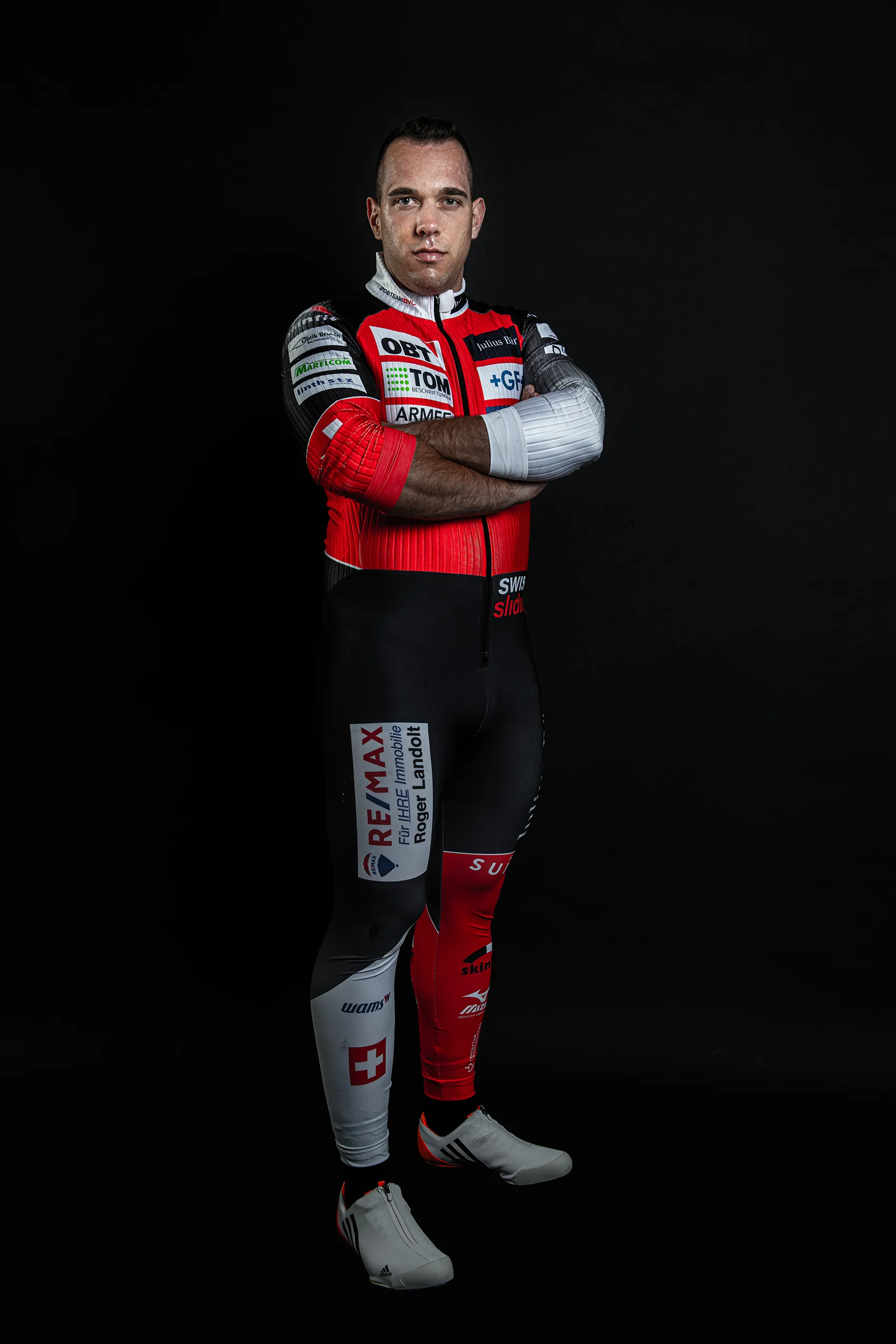 Studio portrait of a Bobteam Vogt athlete in racing suit standing confidently