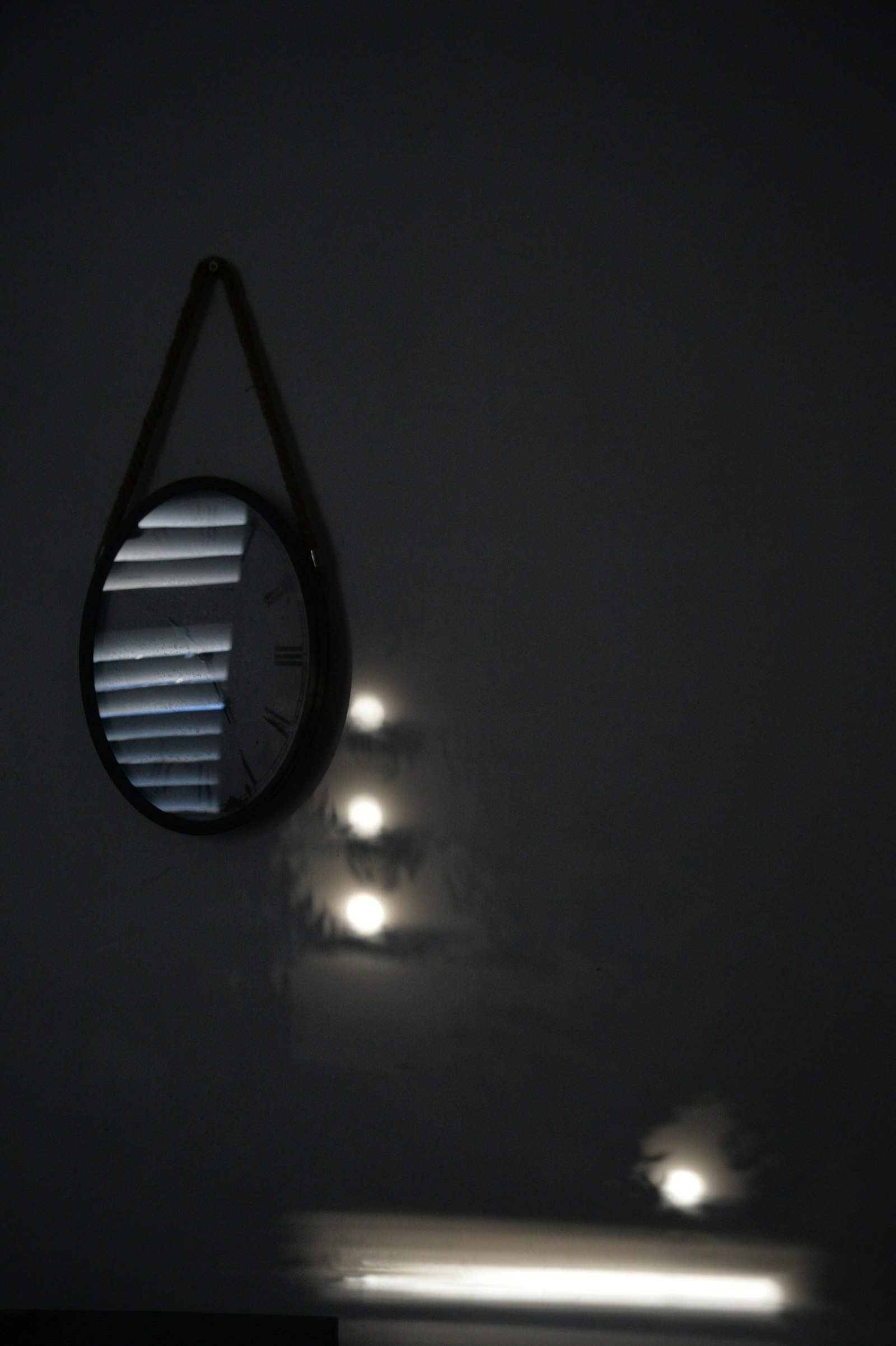 A round mirror reflecting soft window light