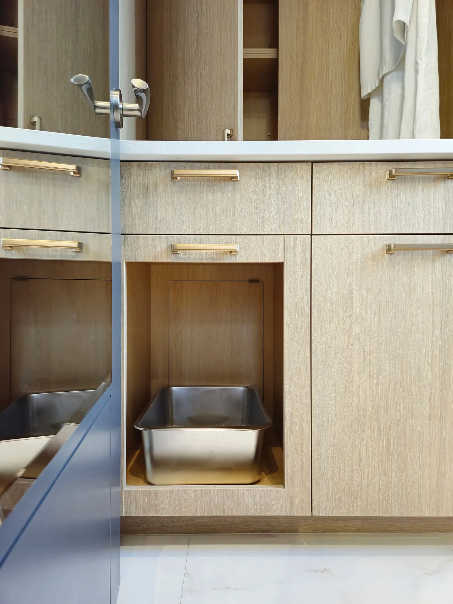Image of laundry room millwork with built in kitty litter.