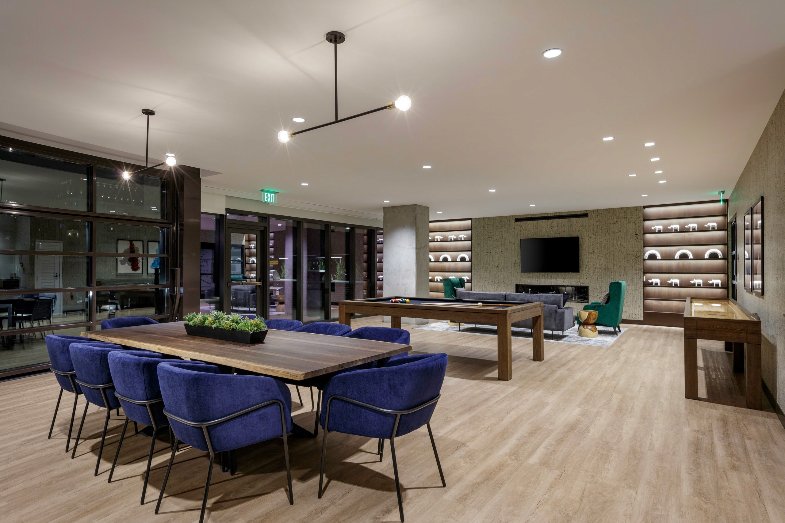 Lounge with dining table, pool, and shuffleboard.