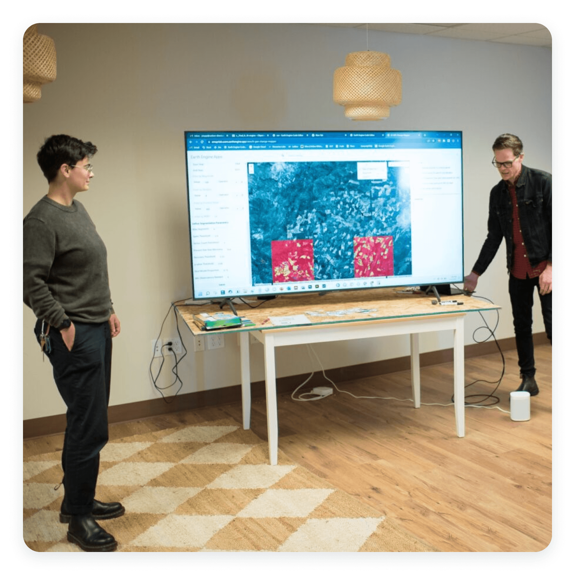 Photograph of two team members presenting in front of a TV
