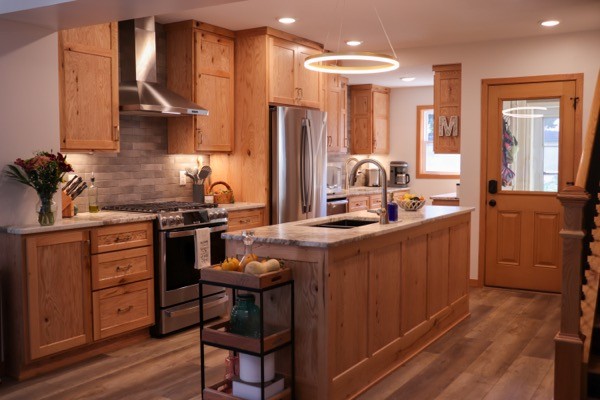 Full kitchen remodel rustic floors light wood cabients slate backsplash