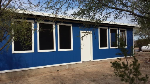 Freshly painted blue home exterior with white trim in Tucson