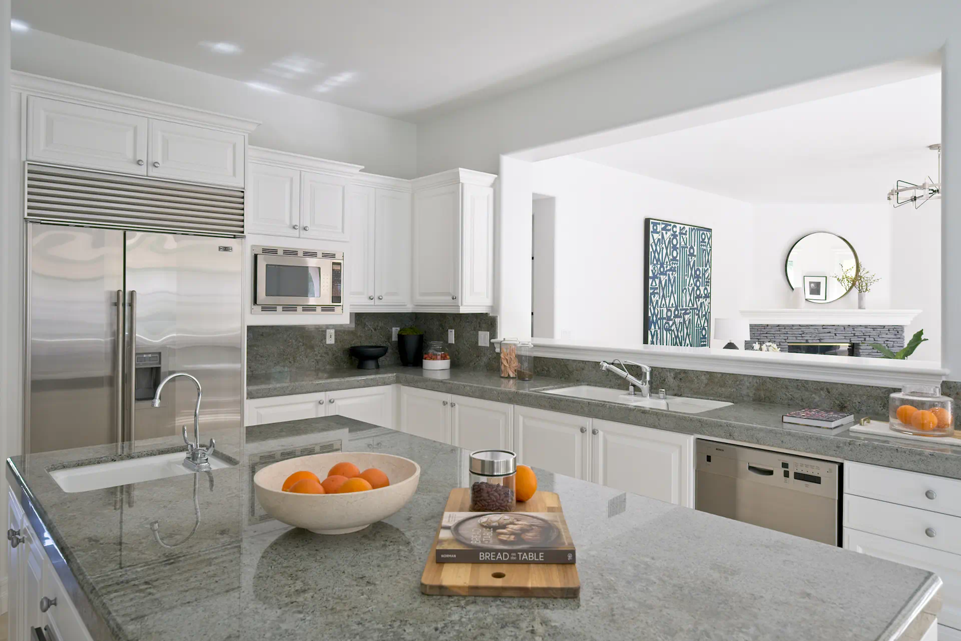 Full view of the kitchen with large island and Sub Zero refrigerator. Photo by Todd Huge.