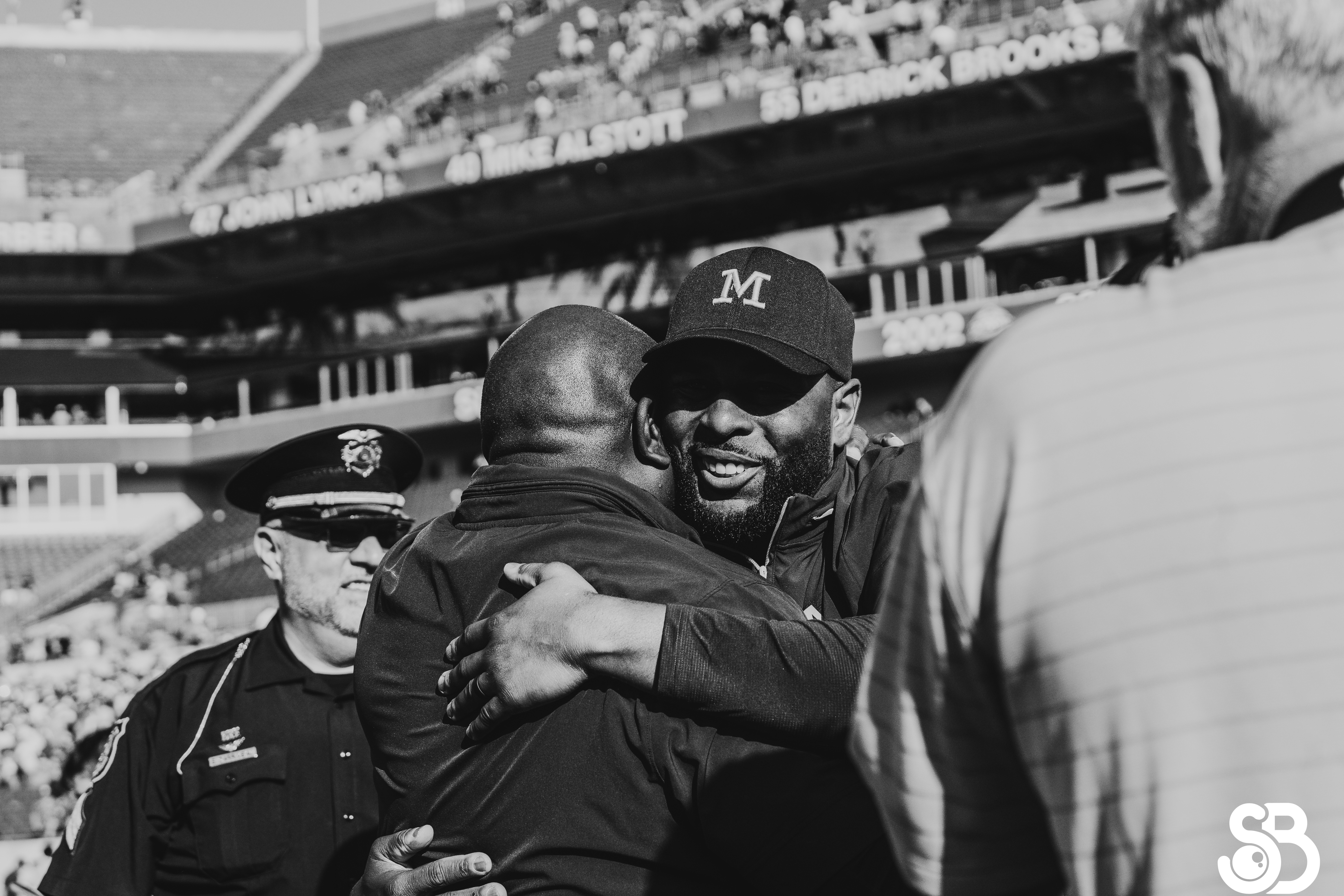 Two men hugging at a sports game