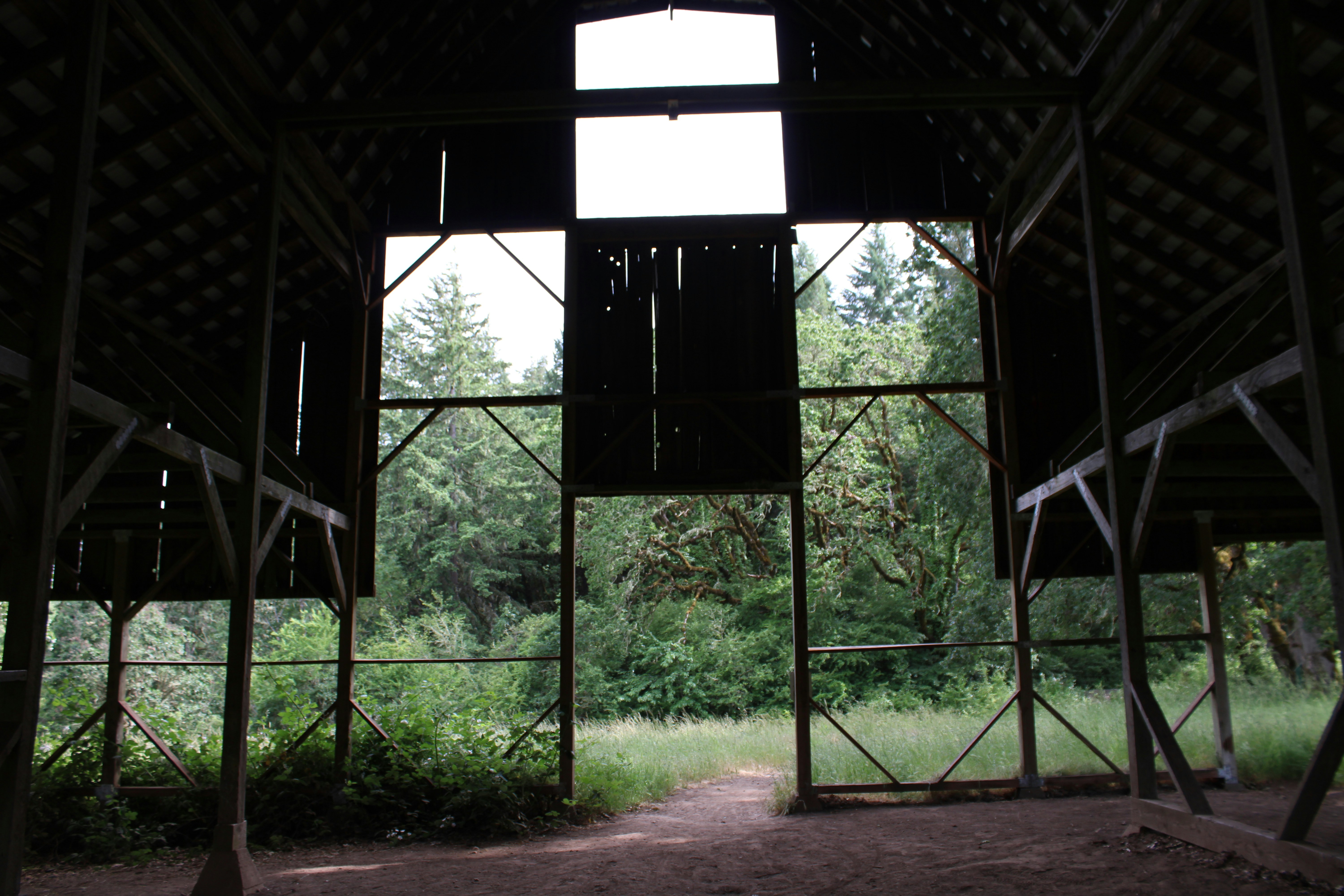 Looking out through the open end of an old timber barn