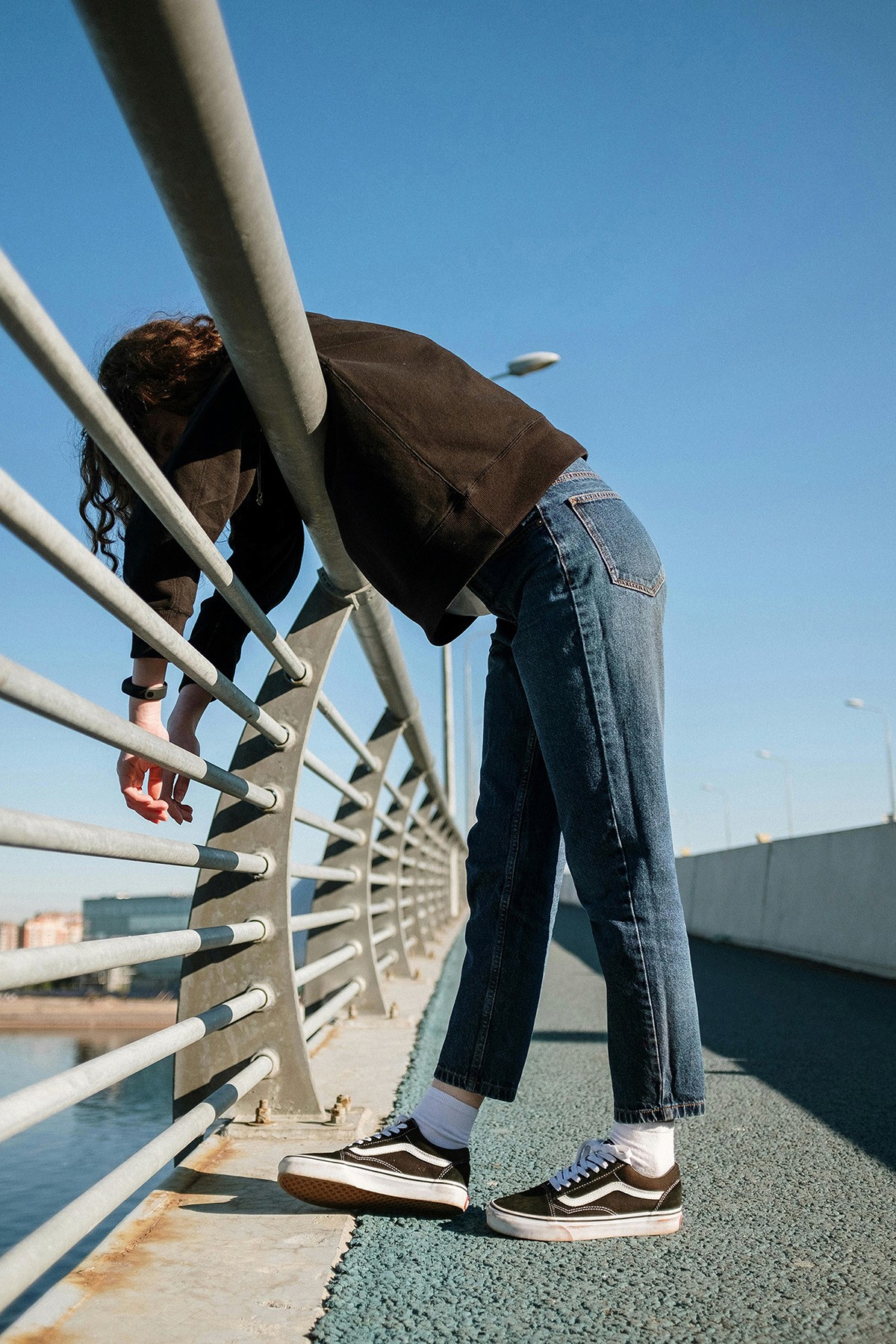 Girl leaning over a railing