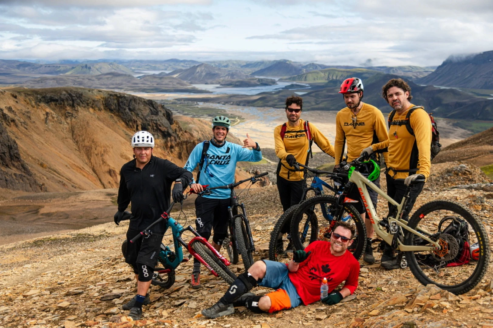 6 men with mountainbikes in Iceland one is lying down in front of the group