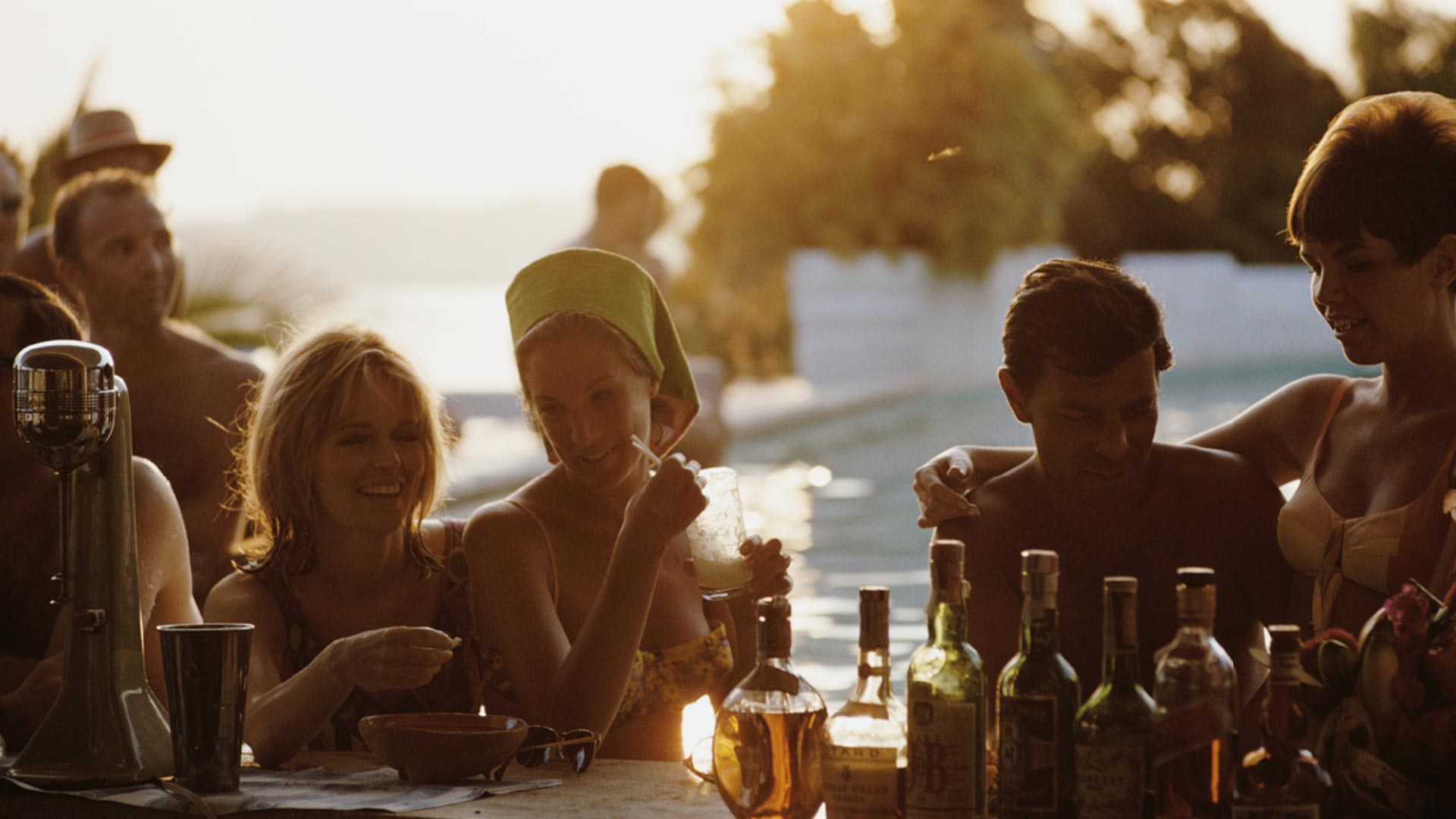 Golden-hour poolside scene with cocktails—capturing the spirit of celebration and connection behind Russell&Stellar’s premium brand storytelling.
