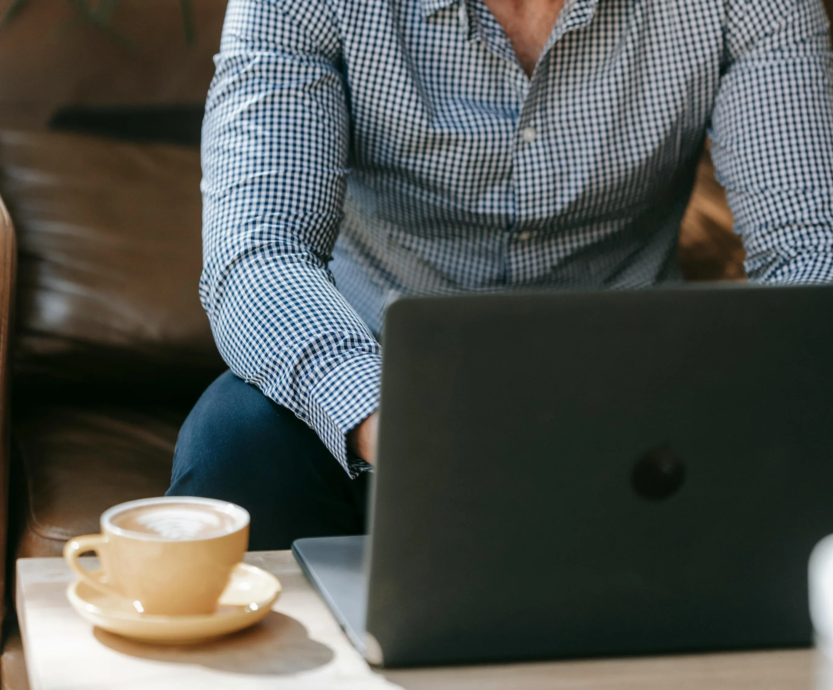 Web designer working on laptop with coffee — RJP.design, a professional NYC web design agency specializing in website design and digital marketing.