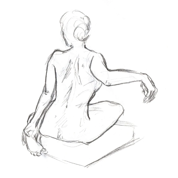 Life drawing of a woman sitting on a cushion on the floor.