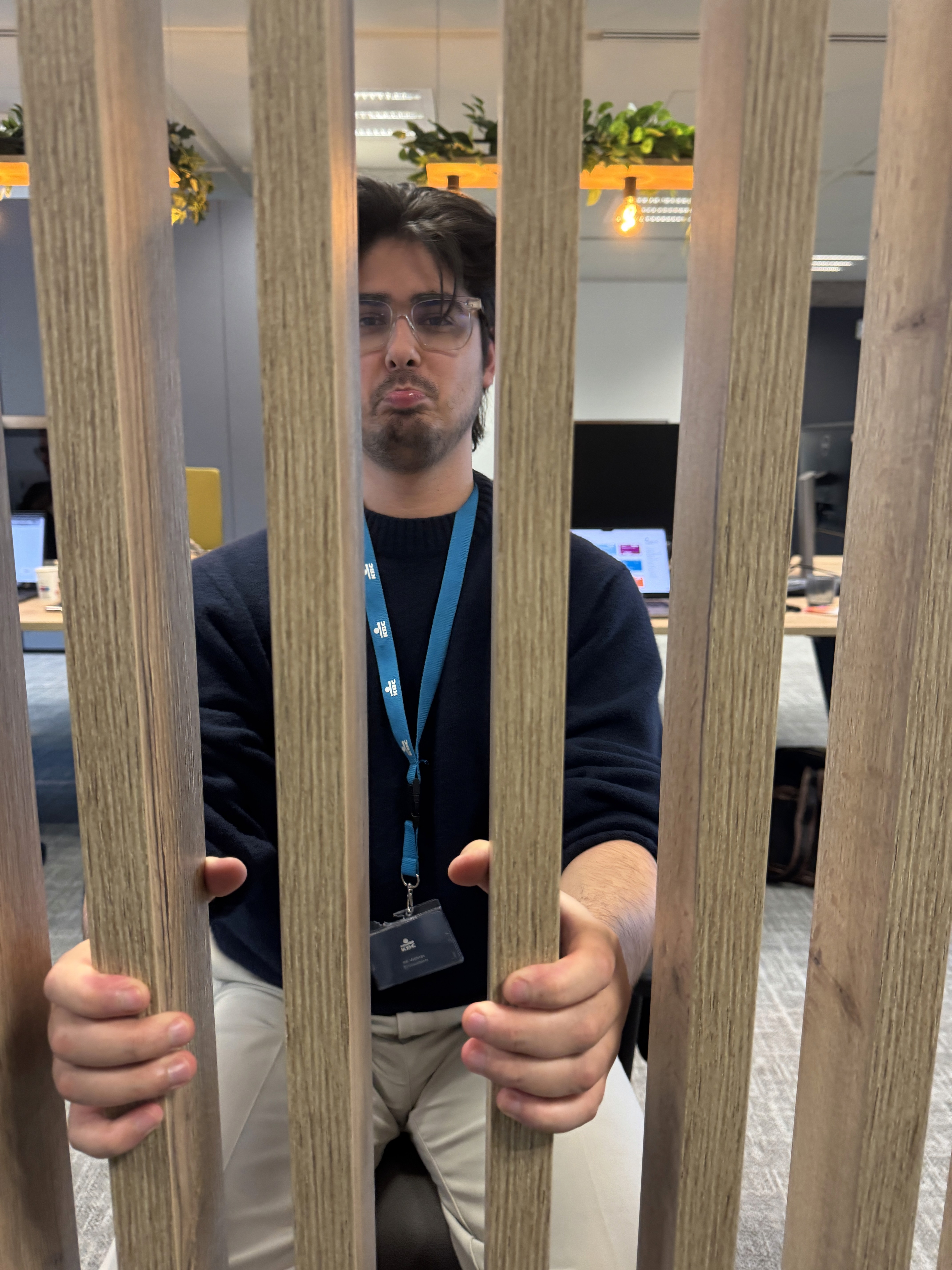 Person sitting on a ledge overlooking New York City skyline