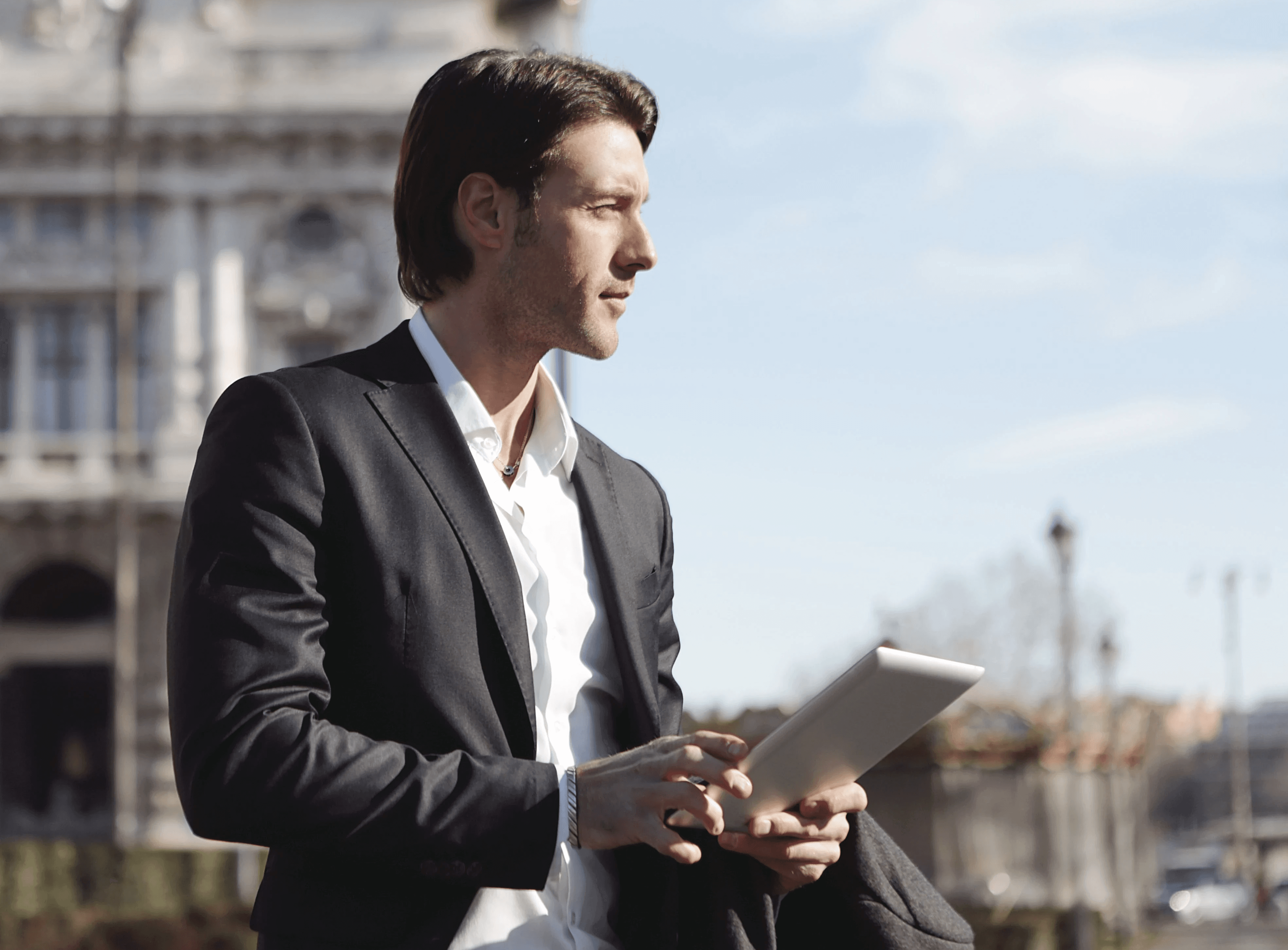 elegant-man-with-tablet-outside-historical-building,-exuding-professional-charm. - andrea-piacquadio (pexels)