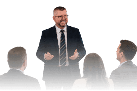 A smiling businessman wearing glasses, a suit, and a tie presenting to an audience, overlaid with a bright orange geometric pattern, illustrating leadership training or a professional presentation.