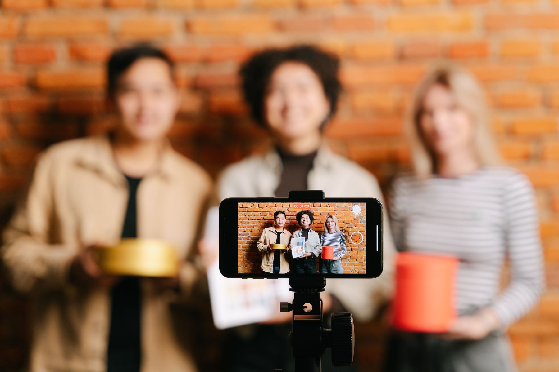 Creators filming a product video with a smartphone