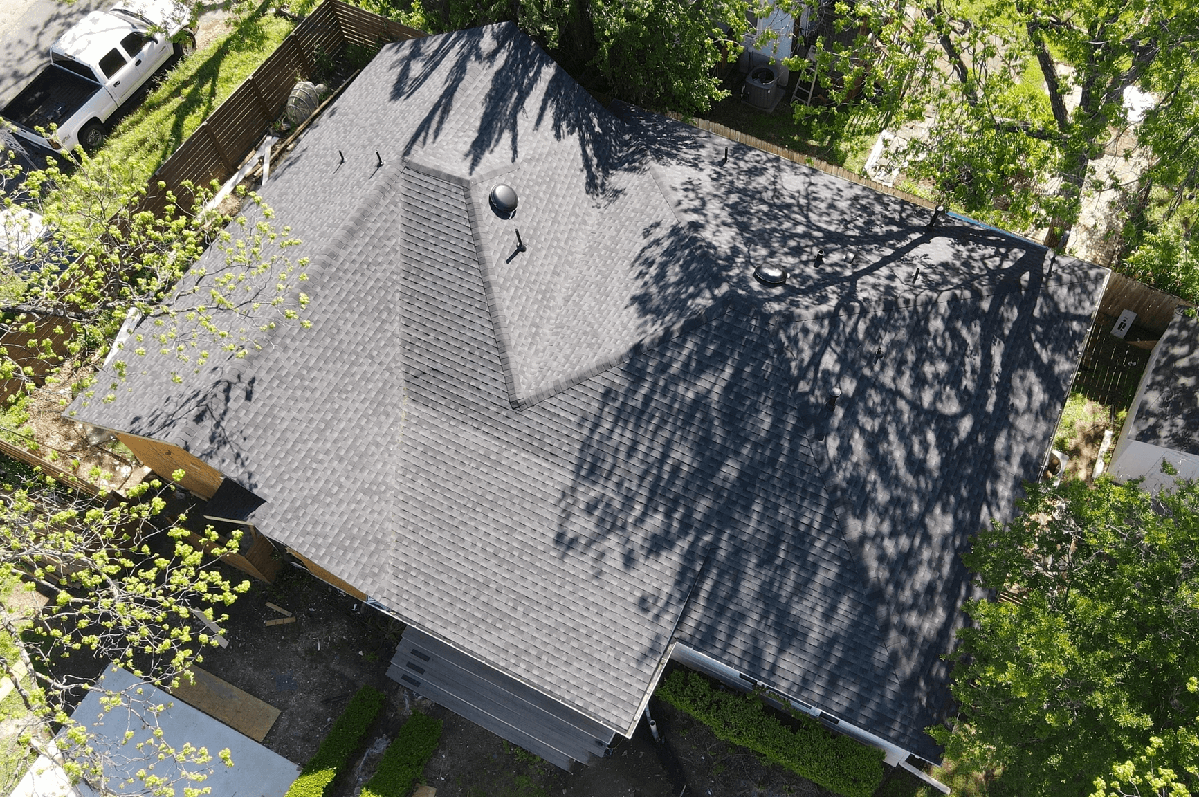 Large house with a GAF Weathered Wood shingle roof, dome vents and featuring a hip and valley design.