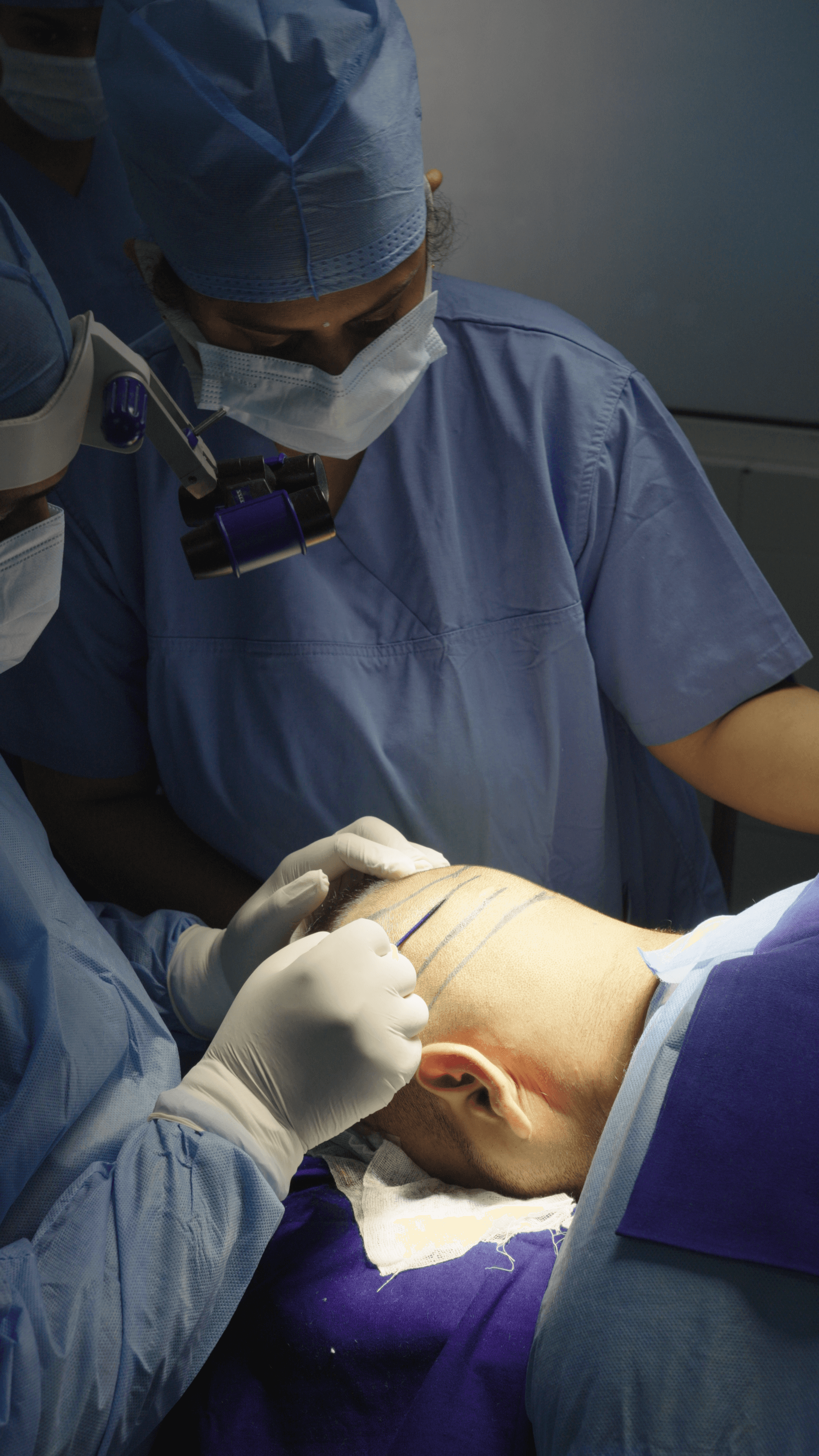 Smiling person with curly hair and nose ring looking over shoulder in bright indoor setting.