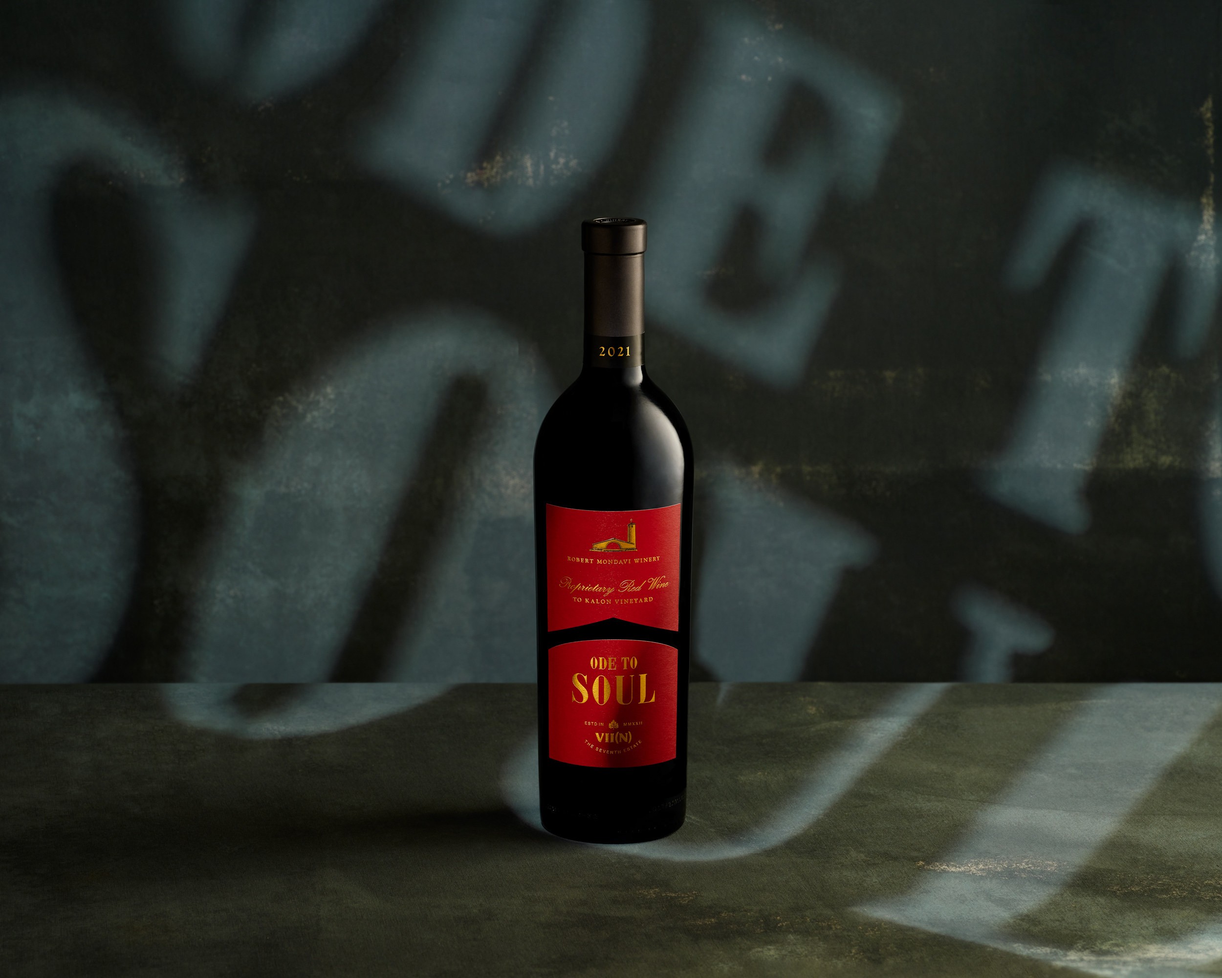 Ode to Soul wine bottle centered against a dark textured surface with sculptural shadows