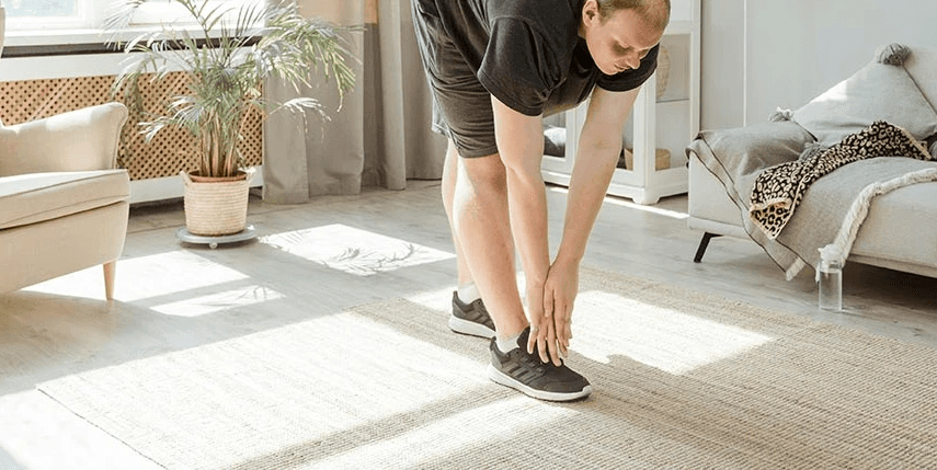 man stretching in his home