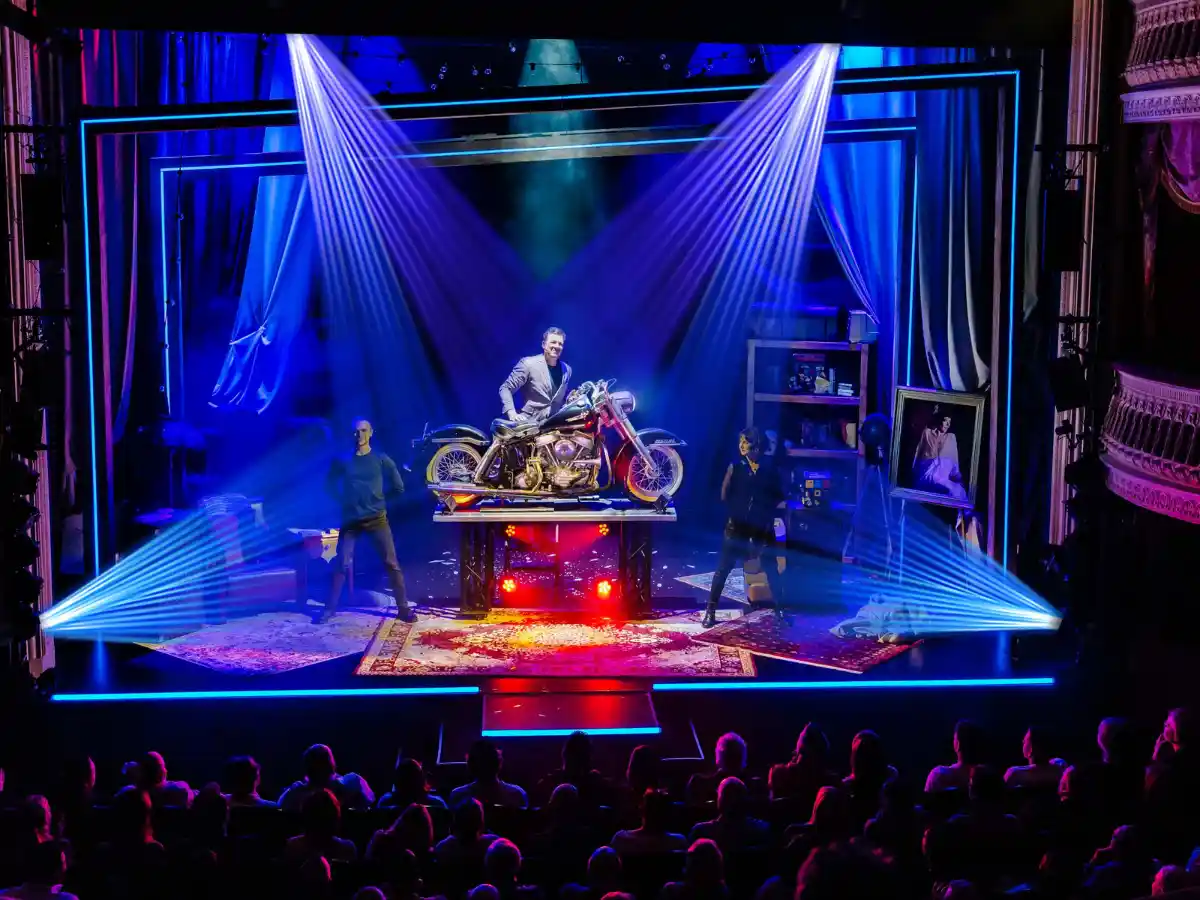 Jamie Allan performing illusions on stage at New World Stages, New York