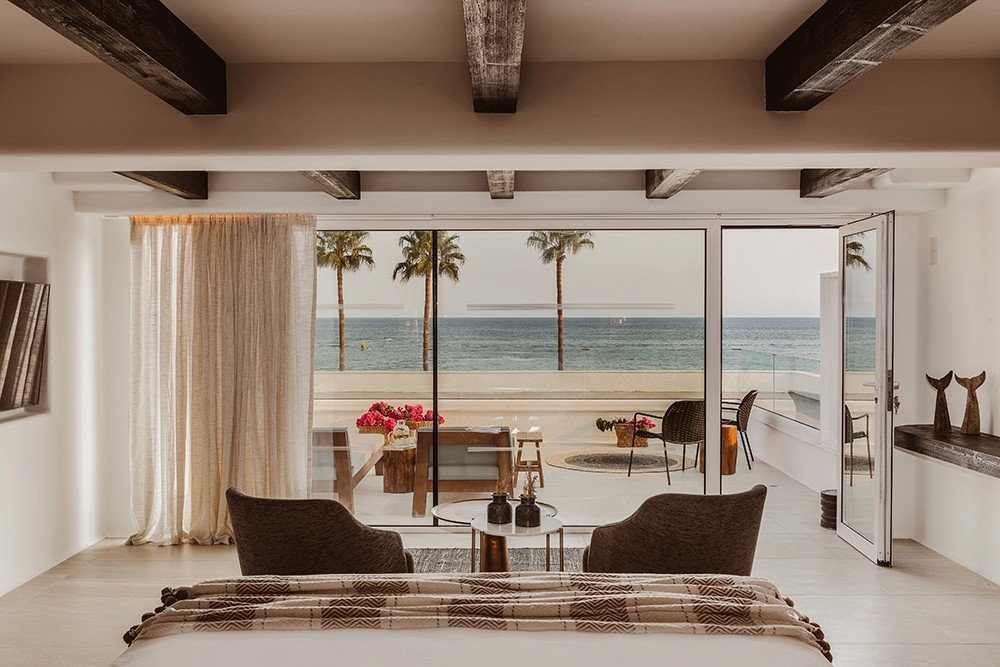 Luxury 5-star junior suite in Ayia Napa featuring Mediterranean-style architecture and custom king-sized bed by topos design studio