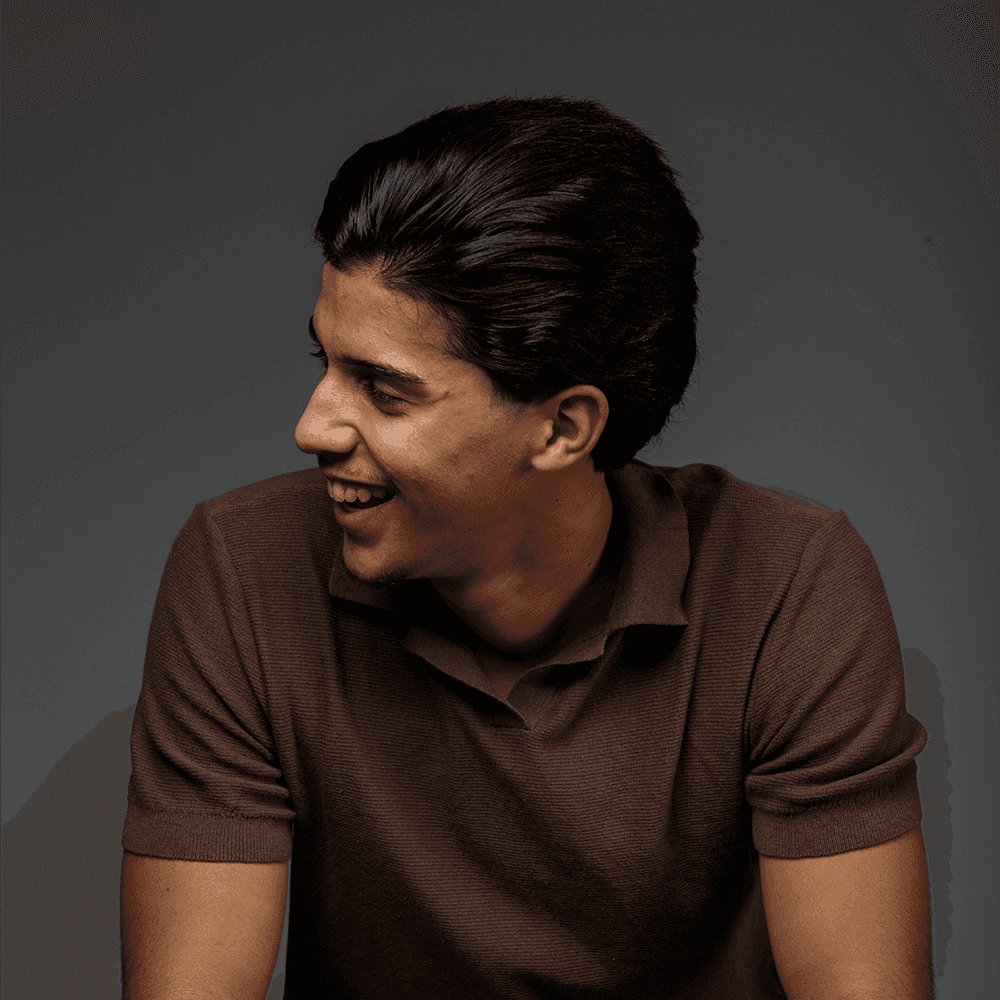 man in gray polo shirt smiling