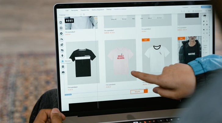 Seller reviewing ecommerce product catalog on tablet to manage product listings and prevent duplicate product listings in online store.