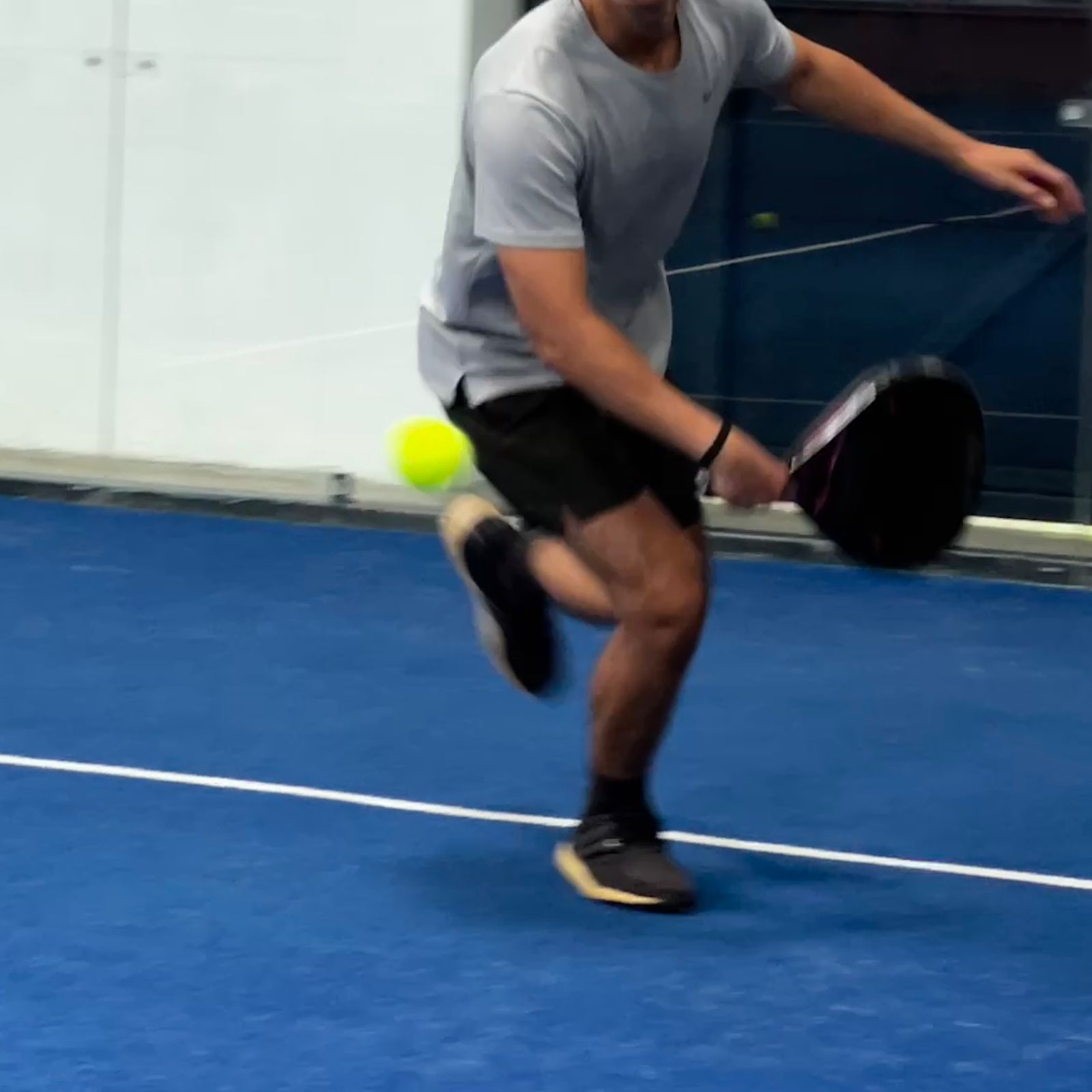 padel equipment on a blue padel court