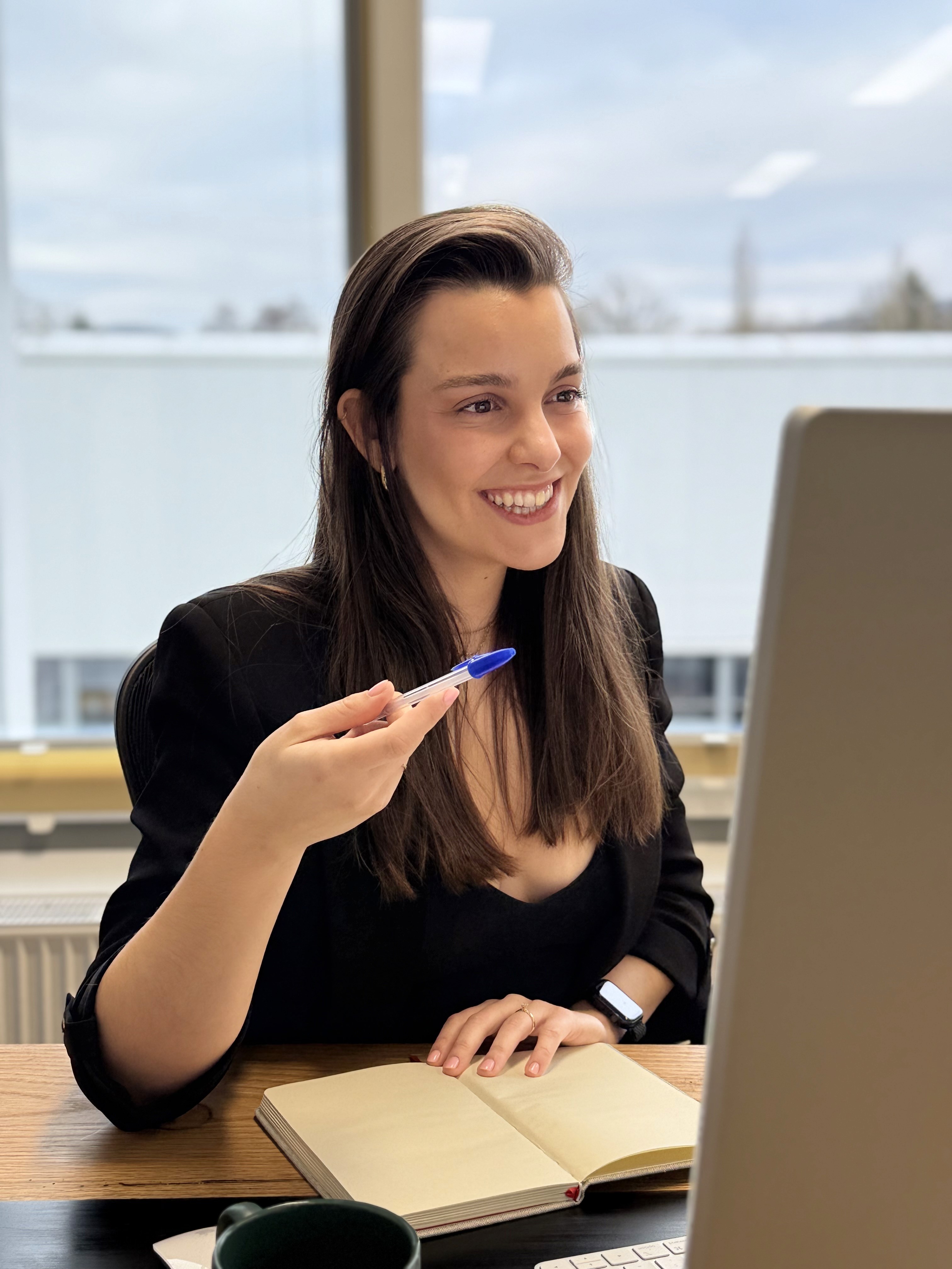 Sofia smiling to a client in a videocall.