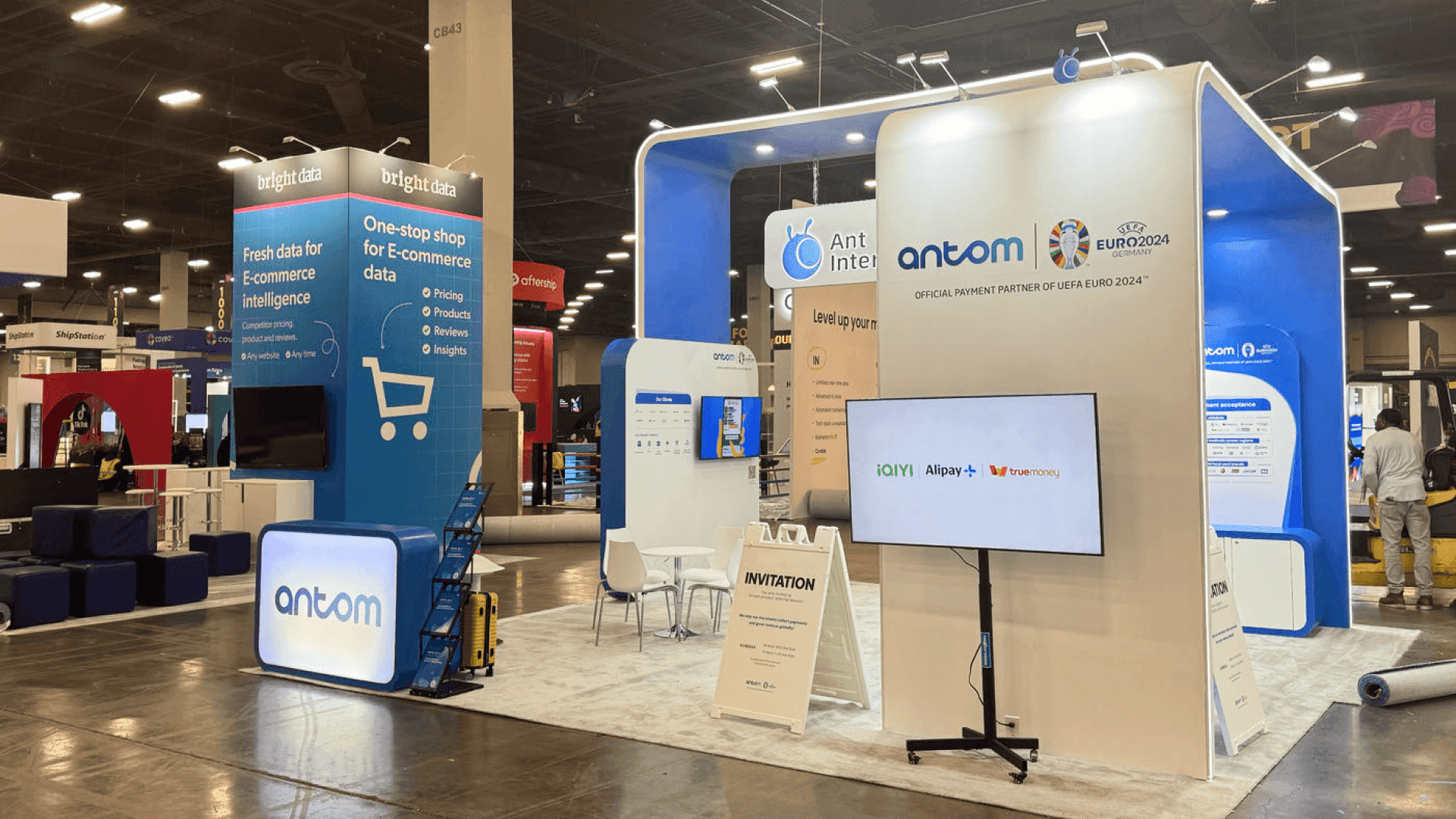 Sabre Industries NATE UNITE 2025 20x20 booth at Raleigh Convention Center with side portal structure, telecom infrastructure branding, and open contractor discussion zone