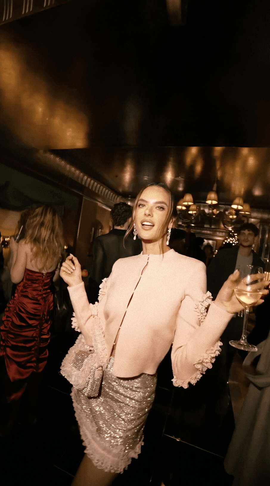 Dancer in black outfit with one leg raised behind