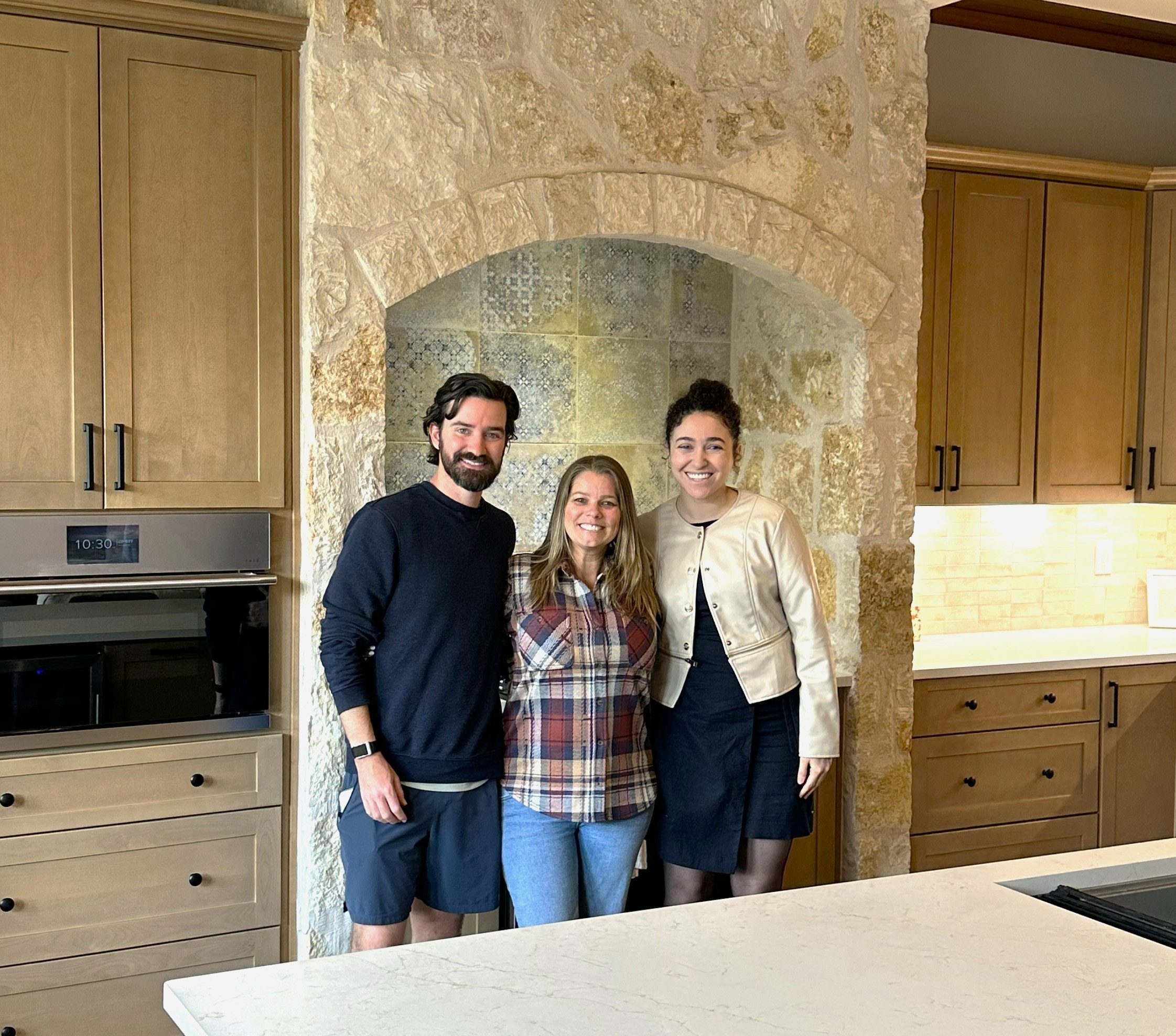 QW Kitchen & Bath design team with satisfied client in completed custom kitchen remodel in Austin Texas