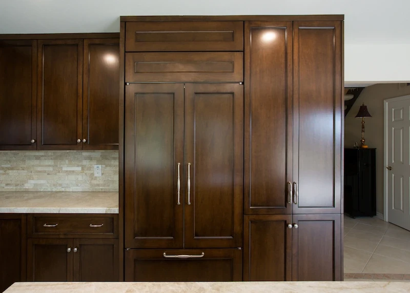 Rich mahogany cabinetry with under-cabinet lighting in a sleek Orange Interior Remodel kitchen.