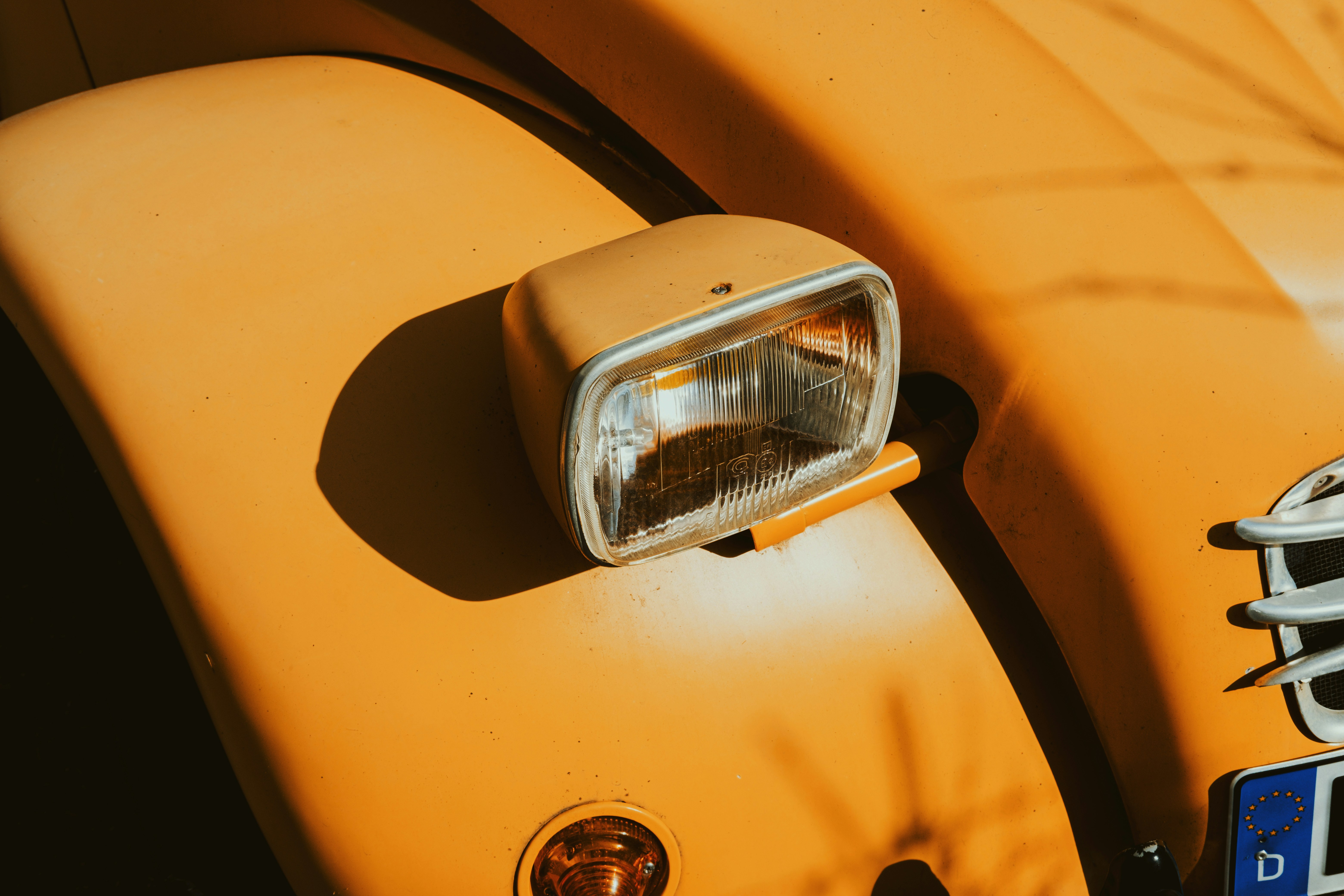 Close-up of an orange vintage car headlight