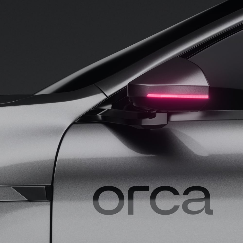 Onboarding screen for the Accident Guardian feature, showing white serif text over an aerial night photograph of a lone car on a motorway, with a Skip link in the top right corner.