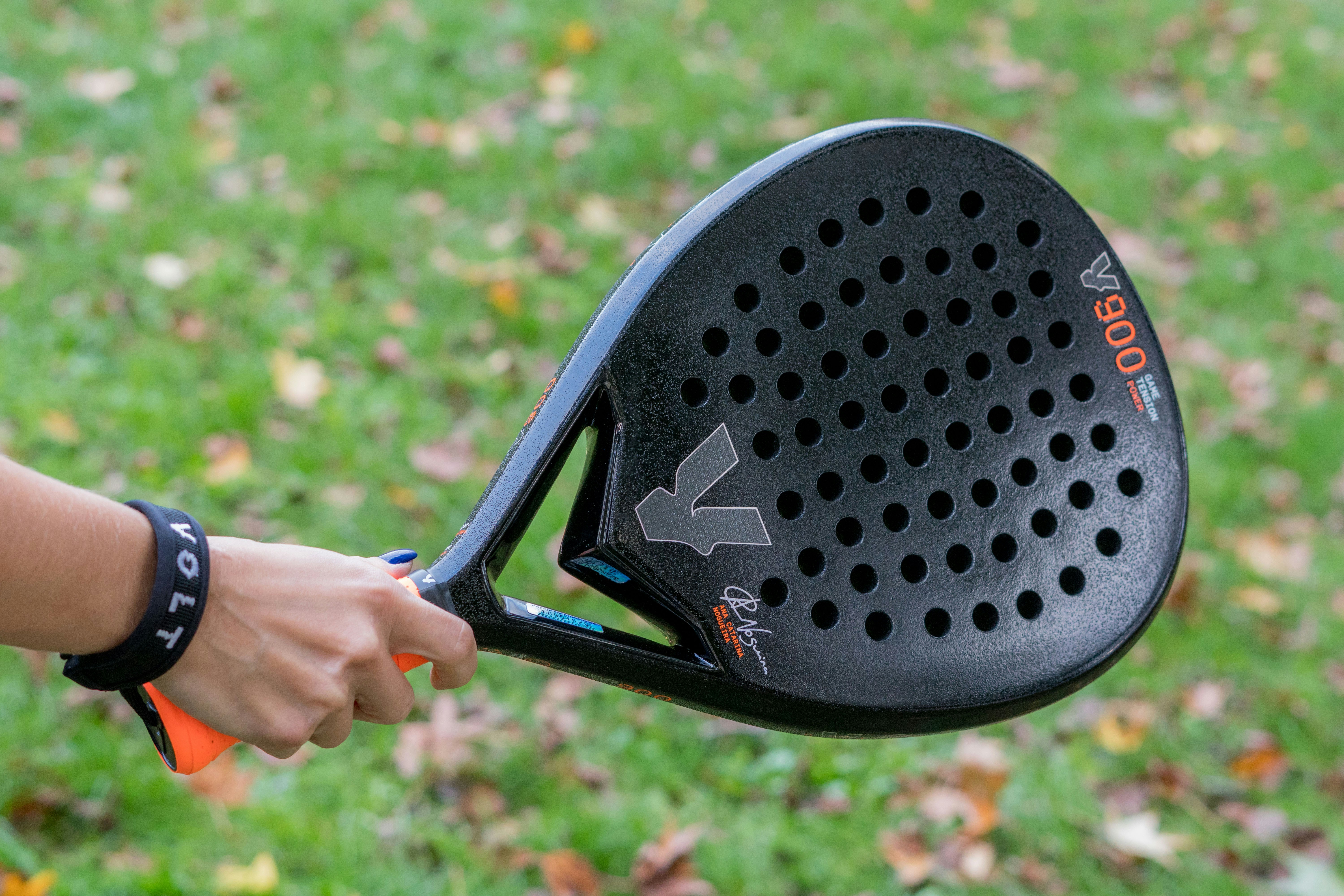 A close up of a person holding a tennis racket