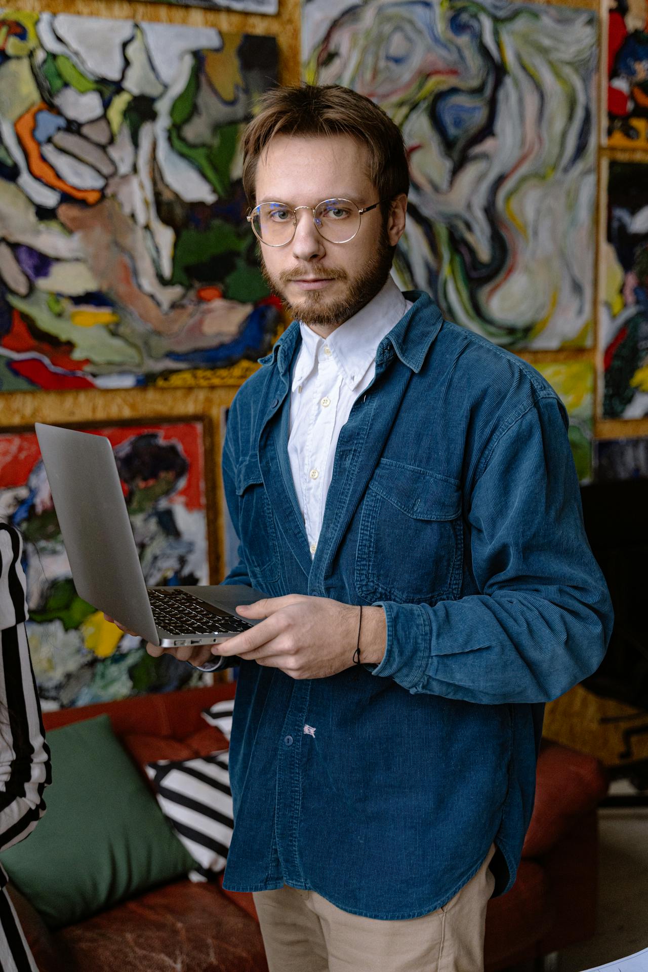 Portrait of Man with Laptop on Art Background
