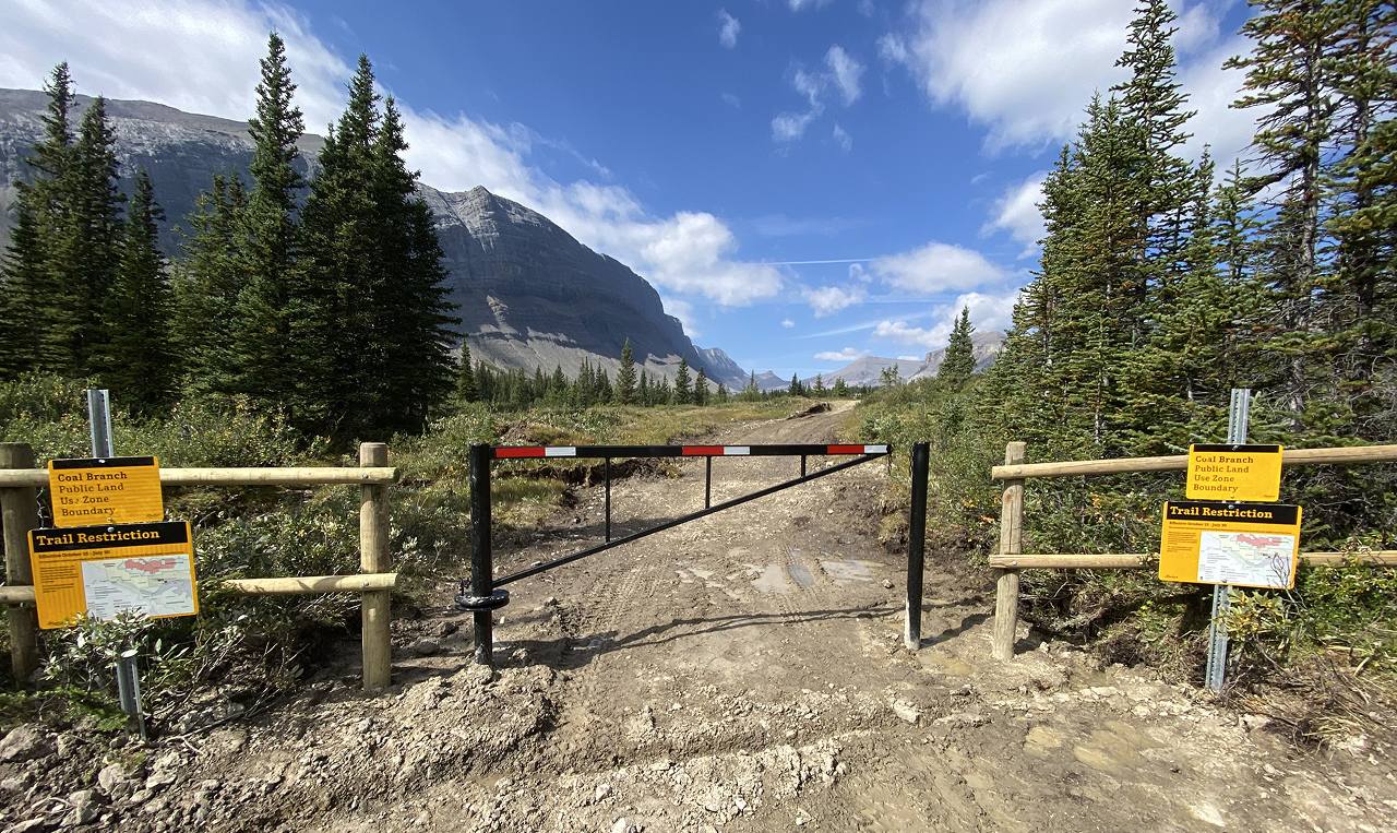 Coal Branch public land use zone boundary gate and trail restriction signage at Cardinal River Headwaters Trail in Whitehorse Wildland Provincial Park