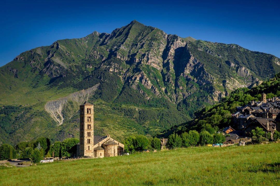 Hiker and angler walking along a Pyrenean river in the Vall de Boí valley