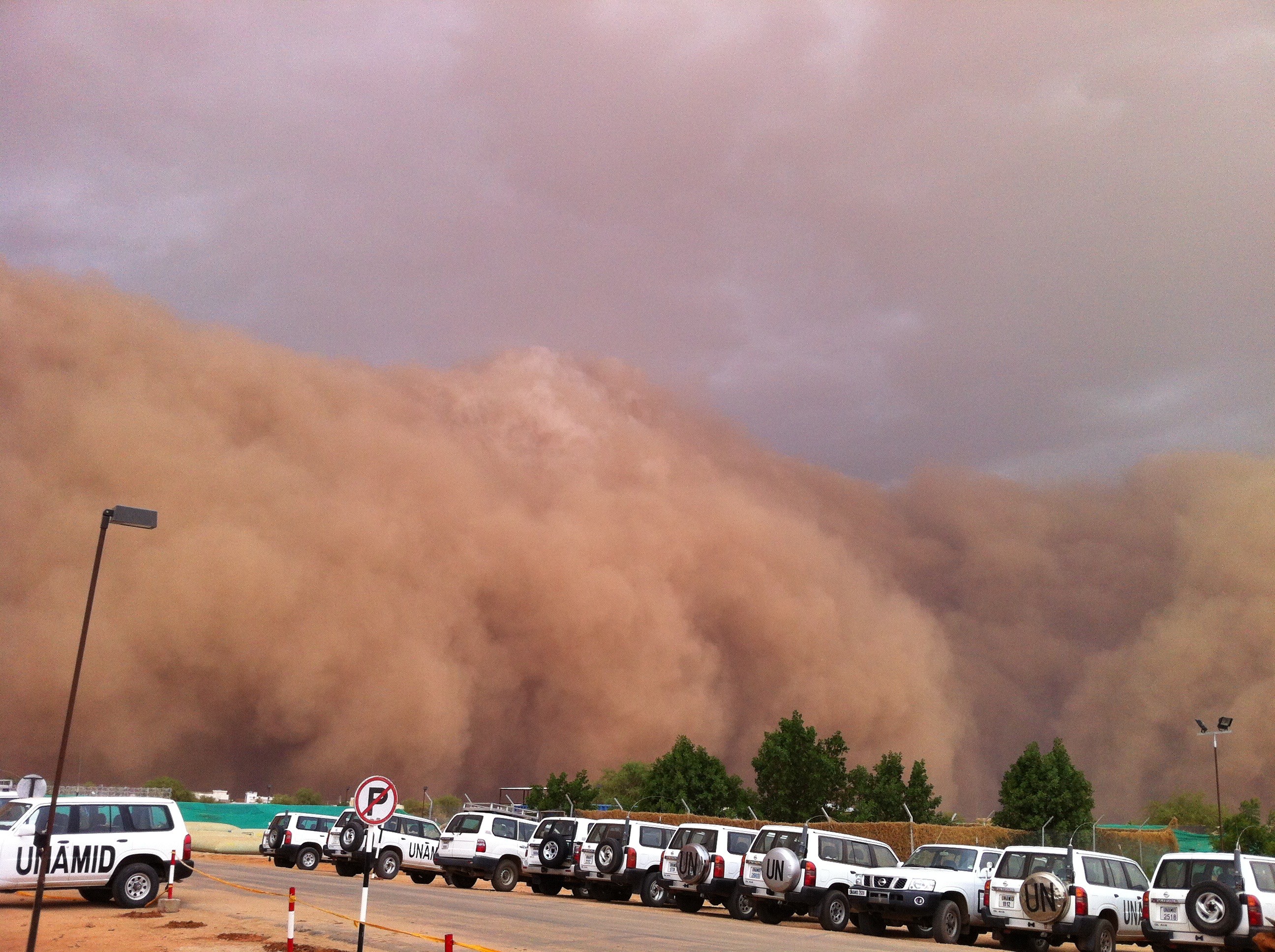 Sandstorm in Sahara desert approaching a United Nations base.